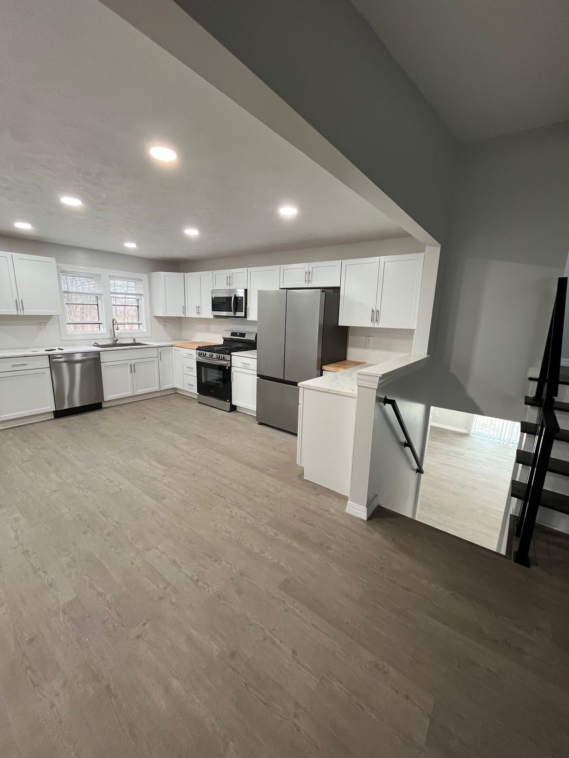 Open kitchen remodeling with new cabinets, flooring, and lighting