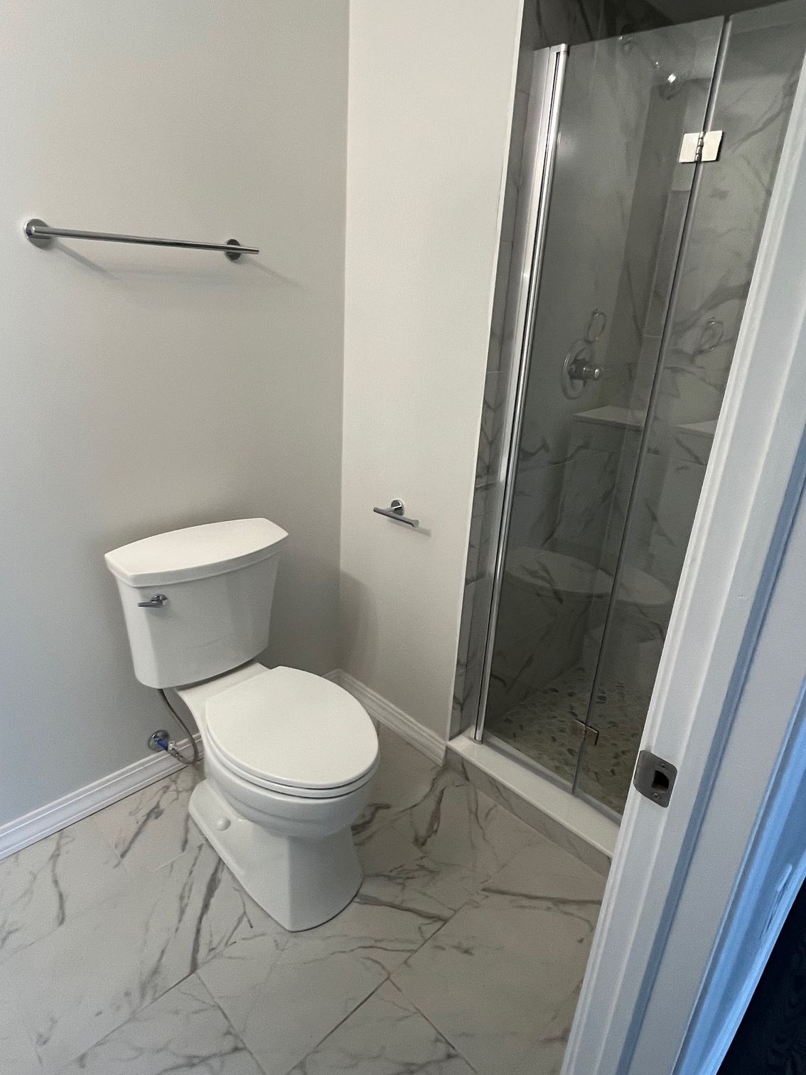 Bathroom shower and toilet installation with tile flooring