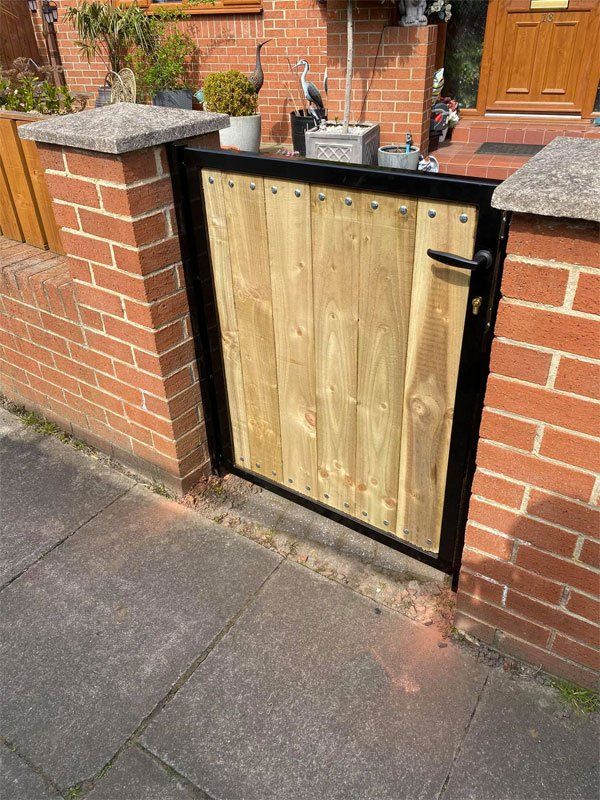 Solid wood garden gate with black charcoal frame