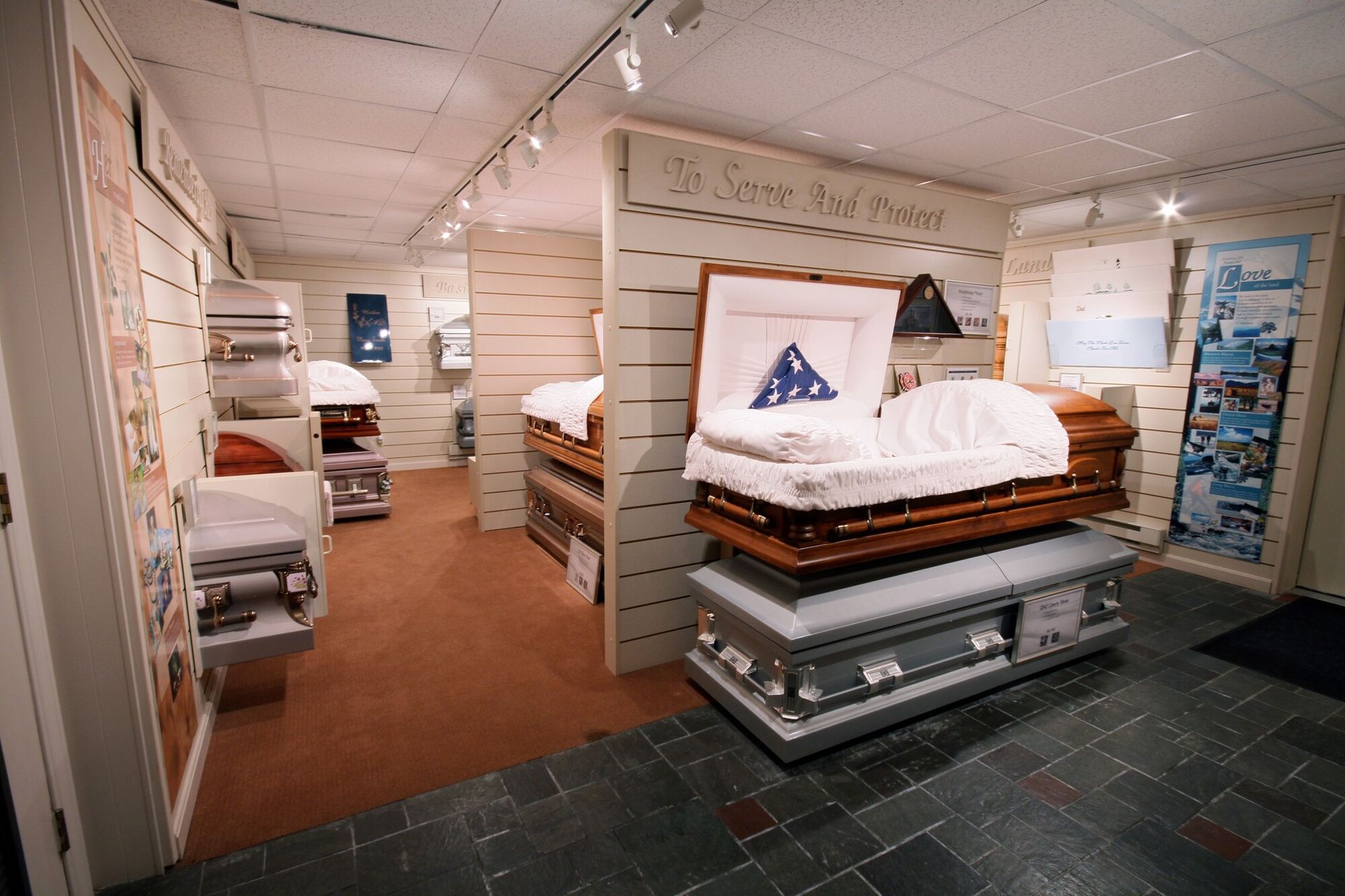 Mattress showroom with neatly displayed beds and bedding samples on slanted display racks