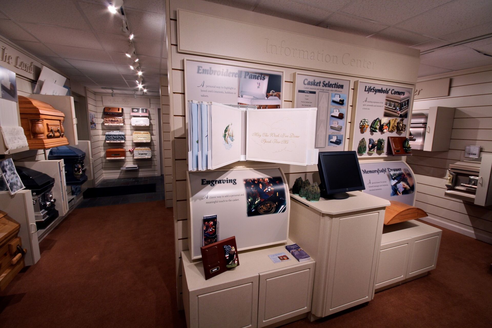 Showroom interior with white cabinets, shelves, and display fixtures under bright lights