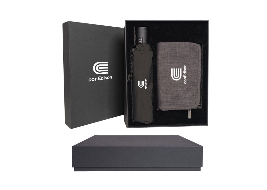 Black gift box with bottle and fabric case inside, plus matching black lid and base.