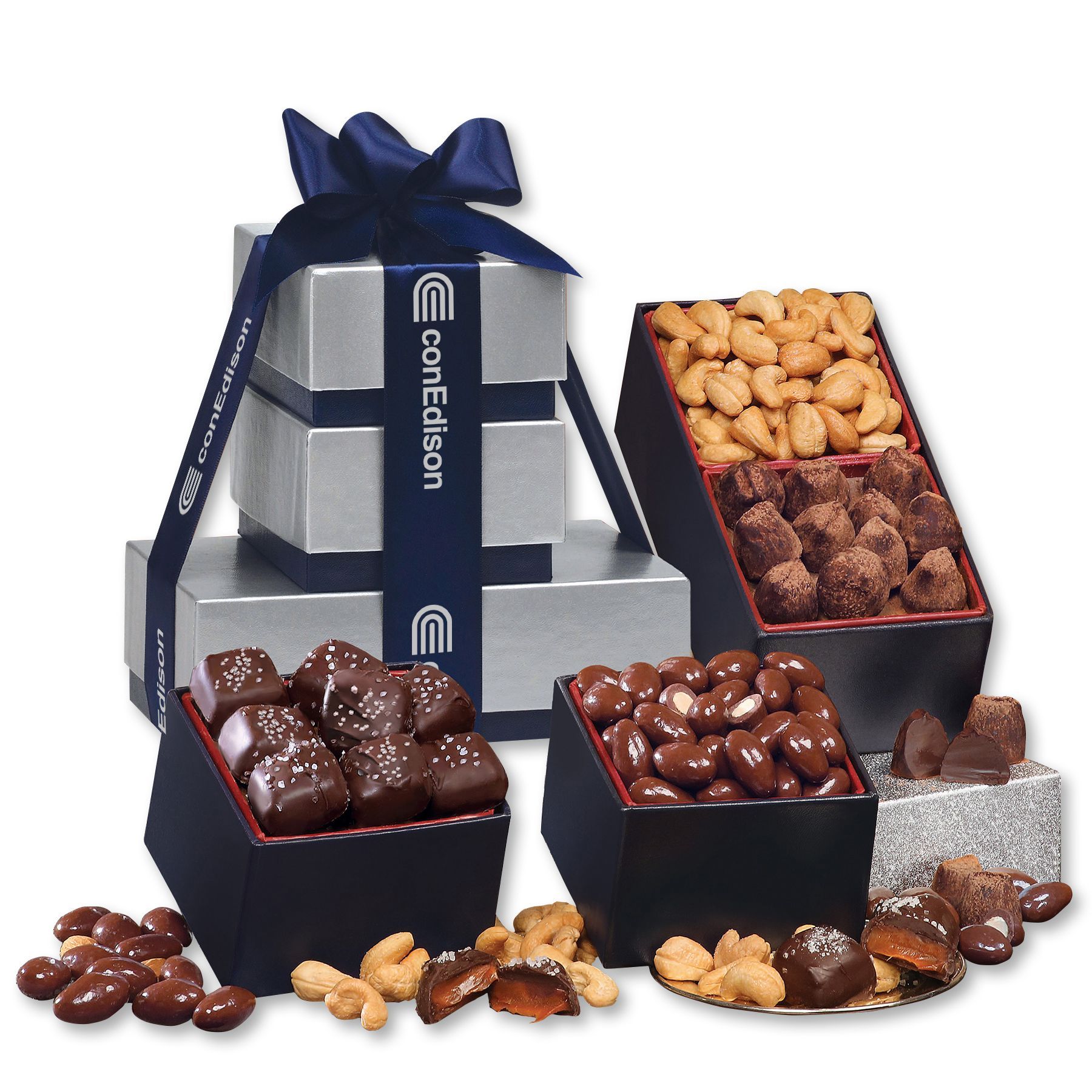 Assorted chocolates and candies in navy gift boxes with silver packaging and a blue bow.