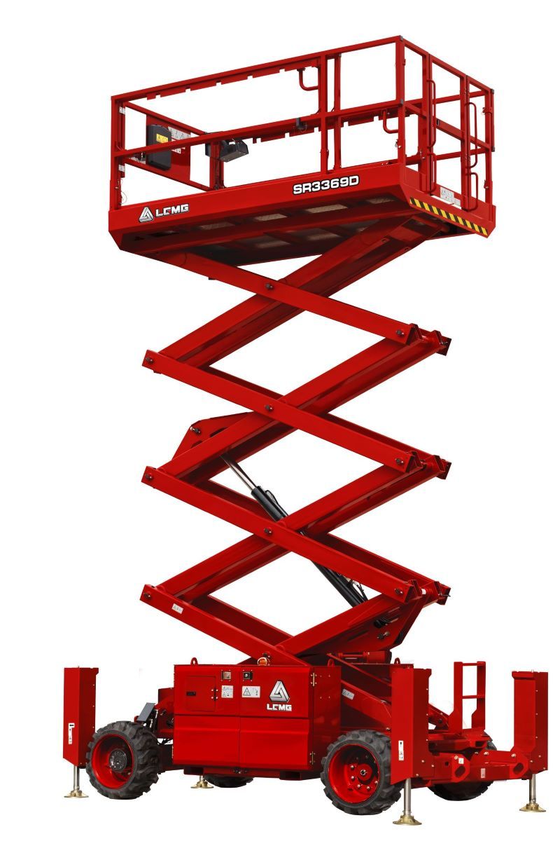 Red scissor electric lift raised high, red industrial work platform on wheels.