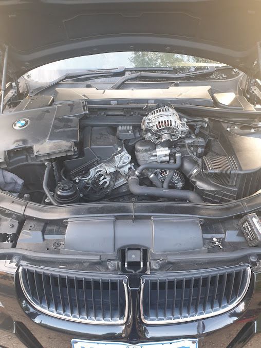 The Engine of a BMW is Shown With the Hood Open — Practic Automotive Services In Bulli, NSW