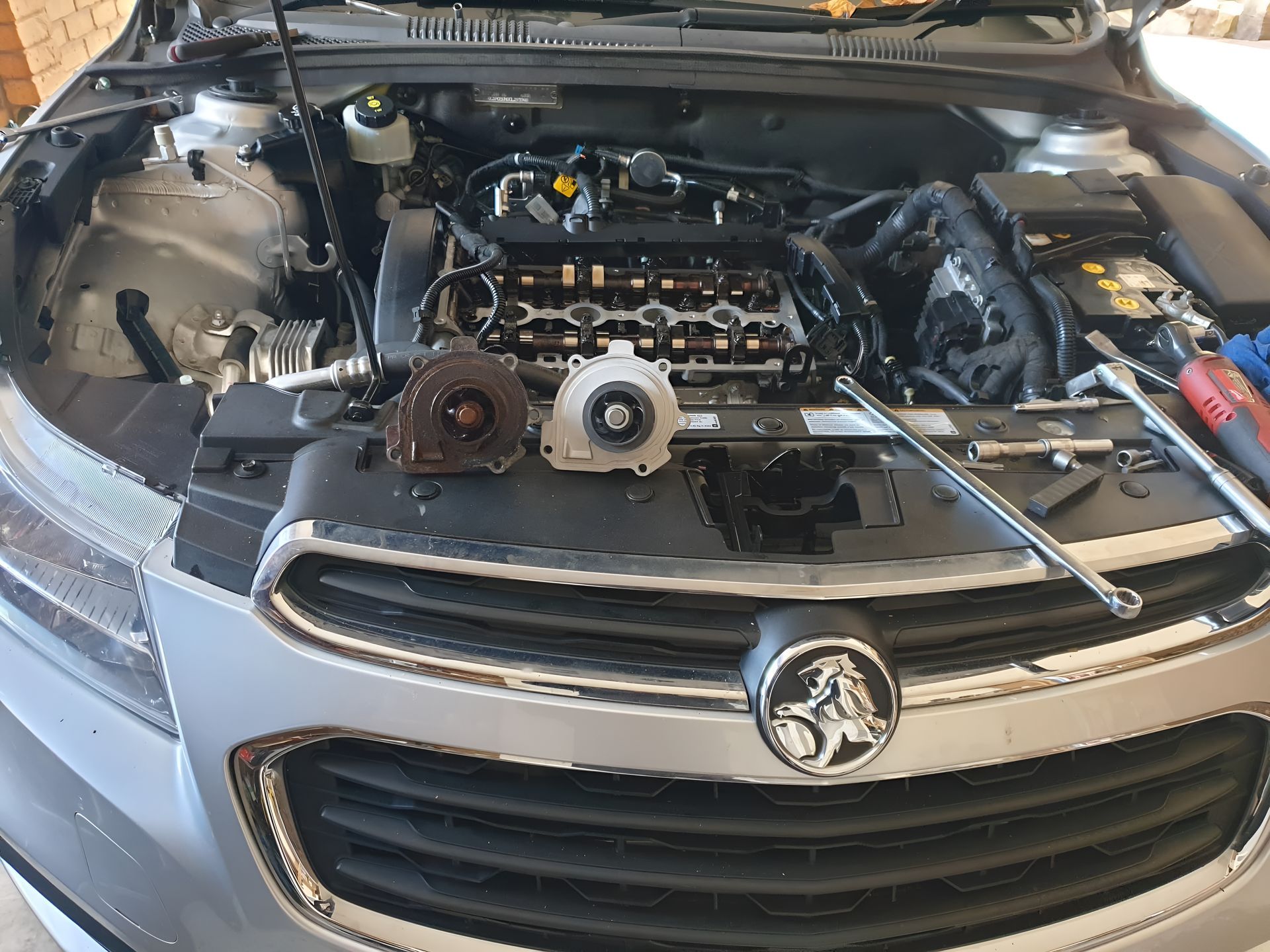 The Hood of a Car is Open and the Engine is Being Worked on — Practic Automotive Services In Austinmer, NSW