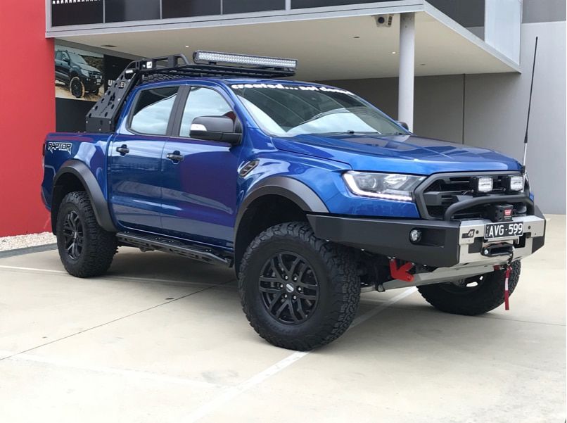 A Blue Ford Ranger is Parked in Front of a Building — Practic Automotive Services In Thirroul, NSW