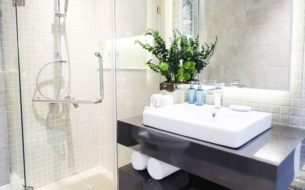 A Bathroom with A Sink, Shower and Mirror — Distinctive Glass In Forster, NSW