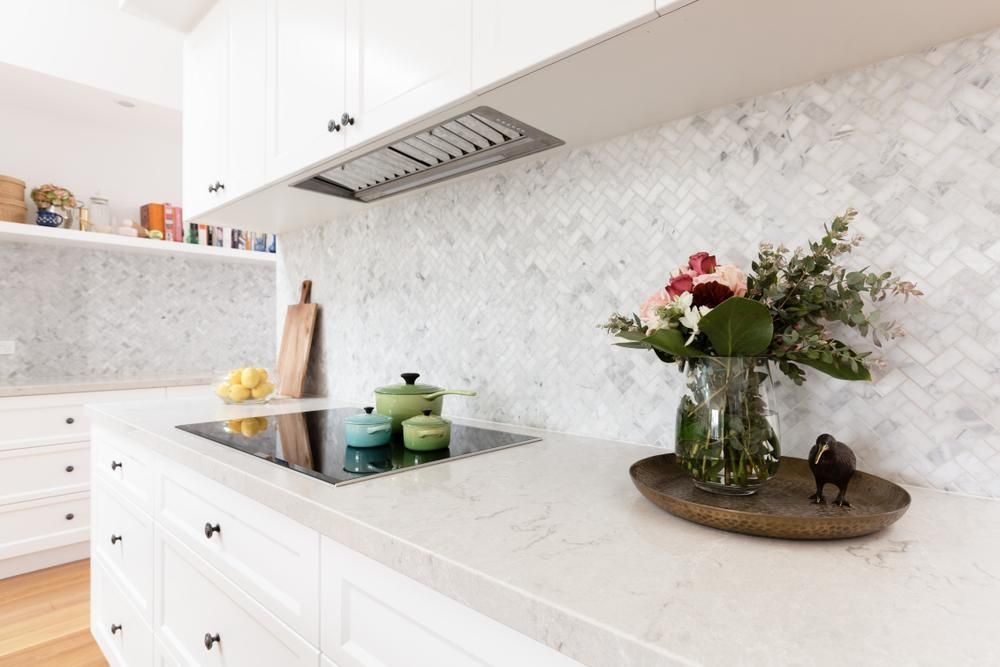 There Is a Vase of Flowers on The Counter in The Kitchen — Distinctive Glass In Toormina, NSW