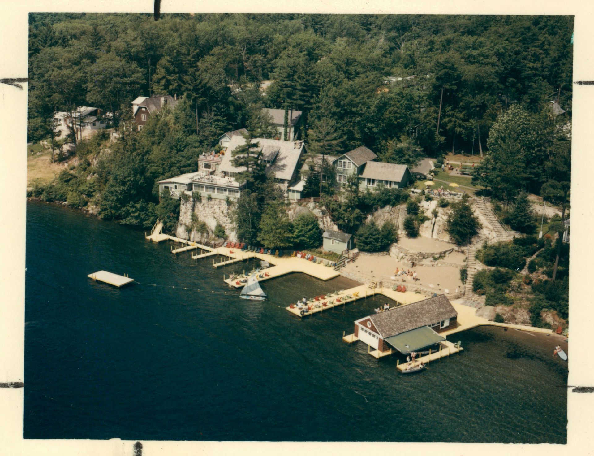 An aerial view of a lake with houses and a dock