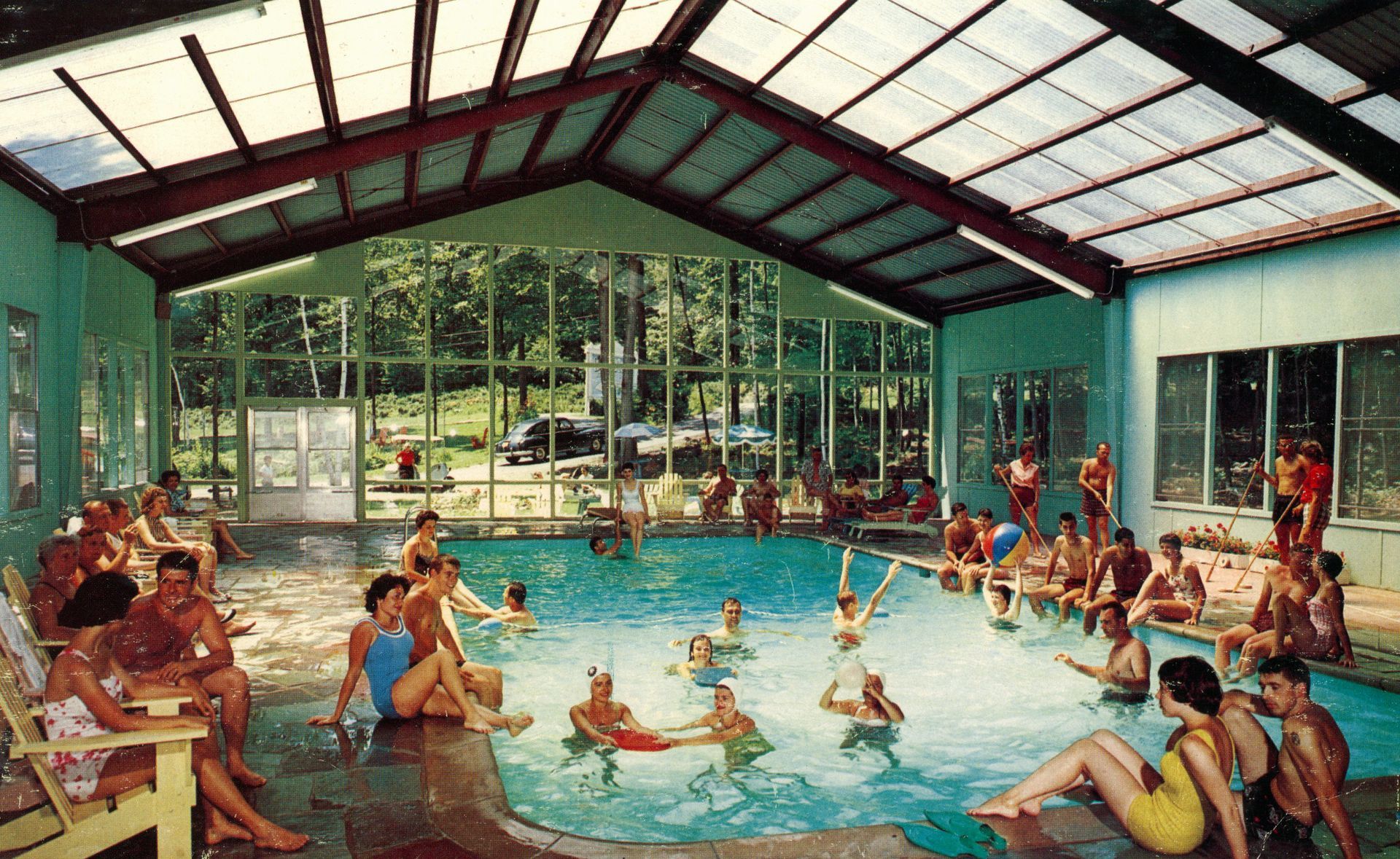 A group of people are swimming in the old BWM indoor swimming pool
