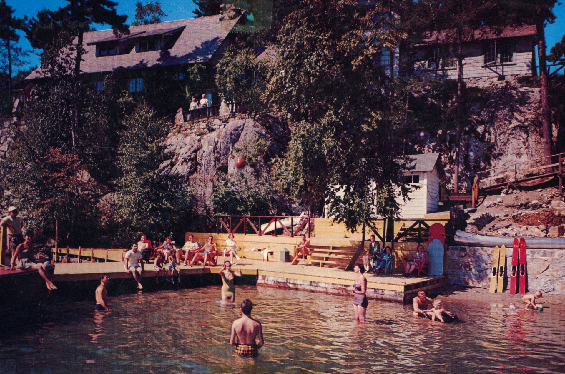 A group of people are swimming in a lake at Blue Water Manor