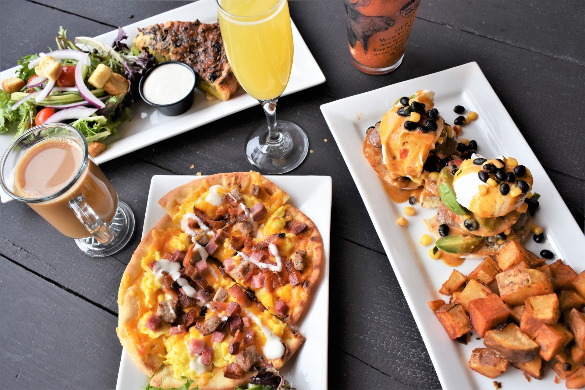 A table topped with plates of food and drinks.