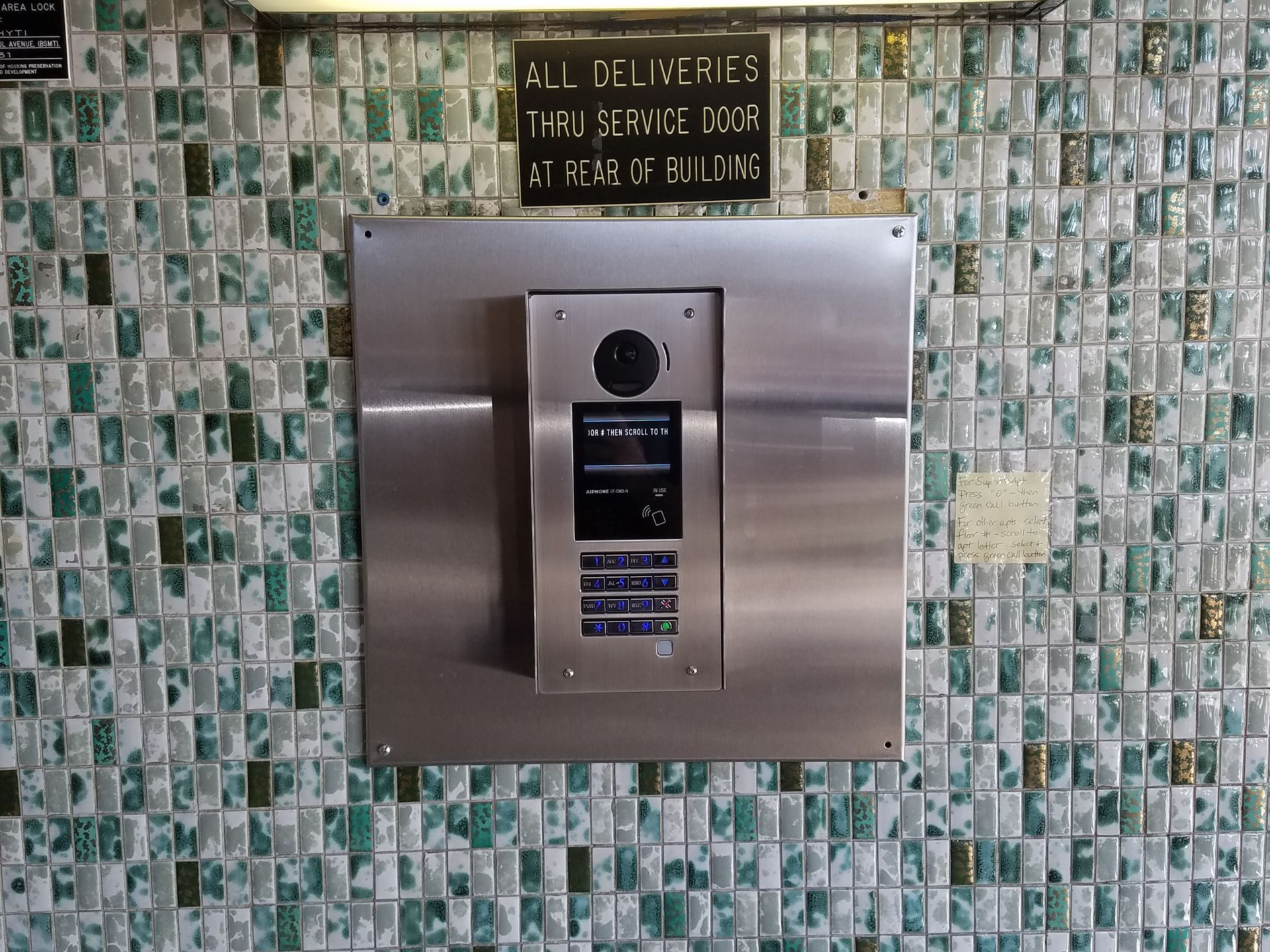 Aiphone GT-DMB-N video intercom panel installed in a Bronx apartment building lobby