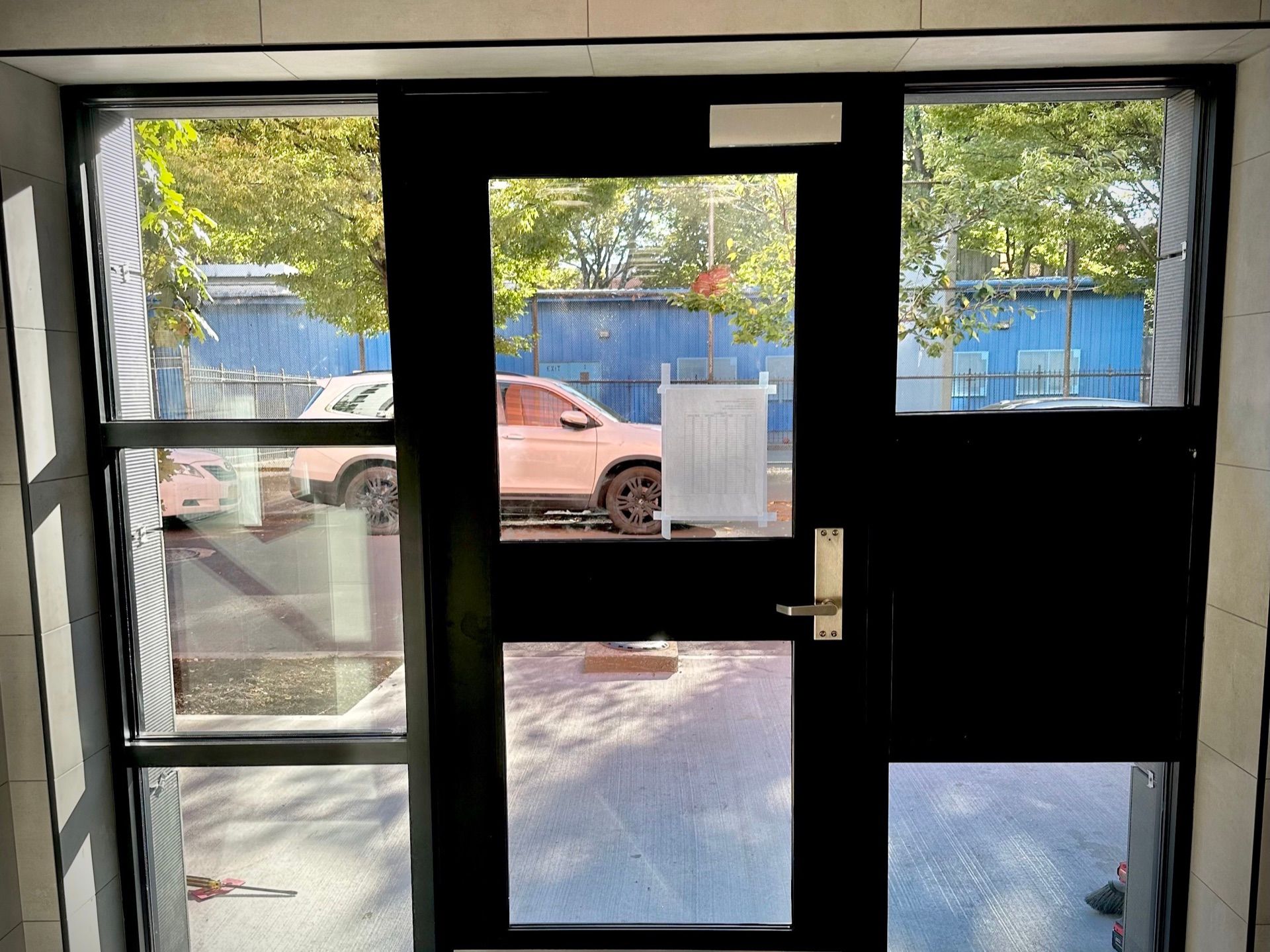 Interior view of new storefront door installed at apartment building in The Bronx