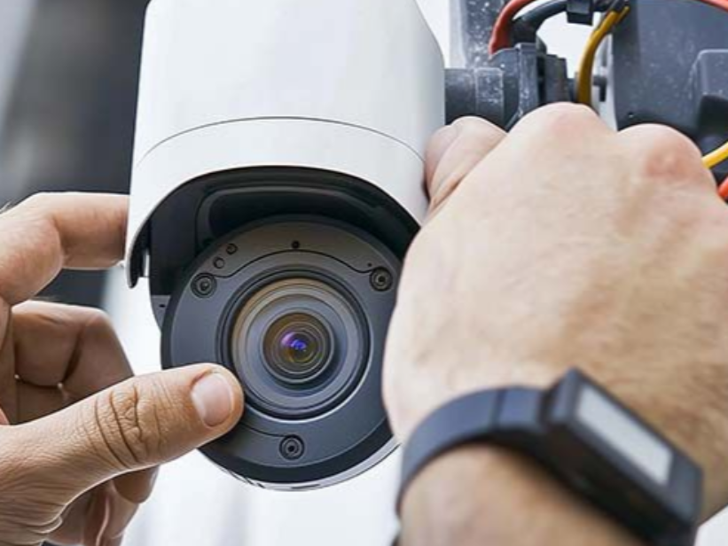 Repairing security camera at building in NYC