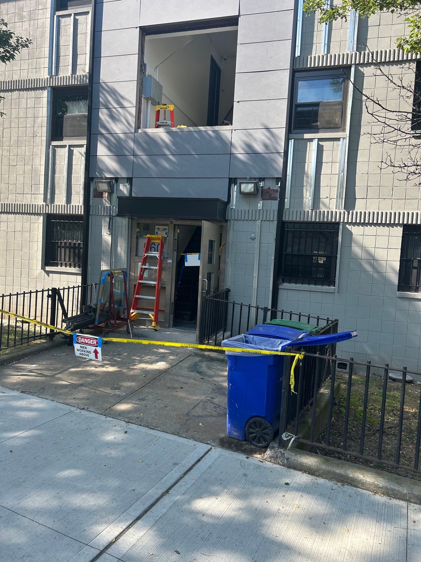 Boom lift positioned for energy-efficient window installation at a Bronx apartment building managed by a multifamily property group — Parker Custom Security