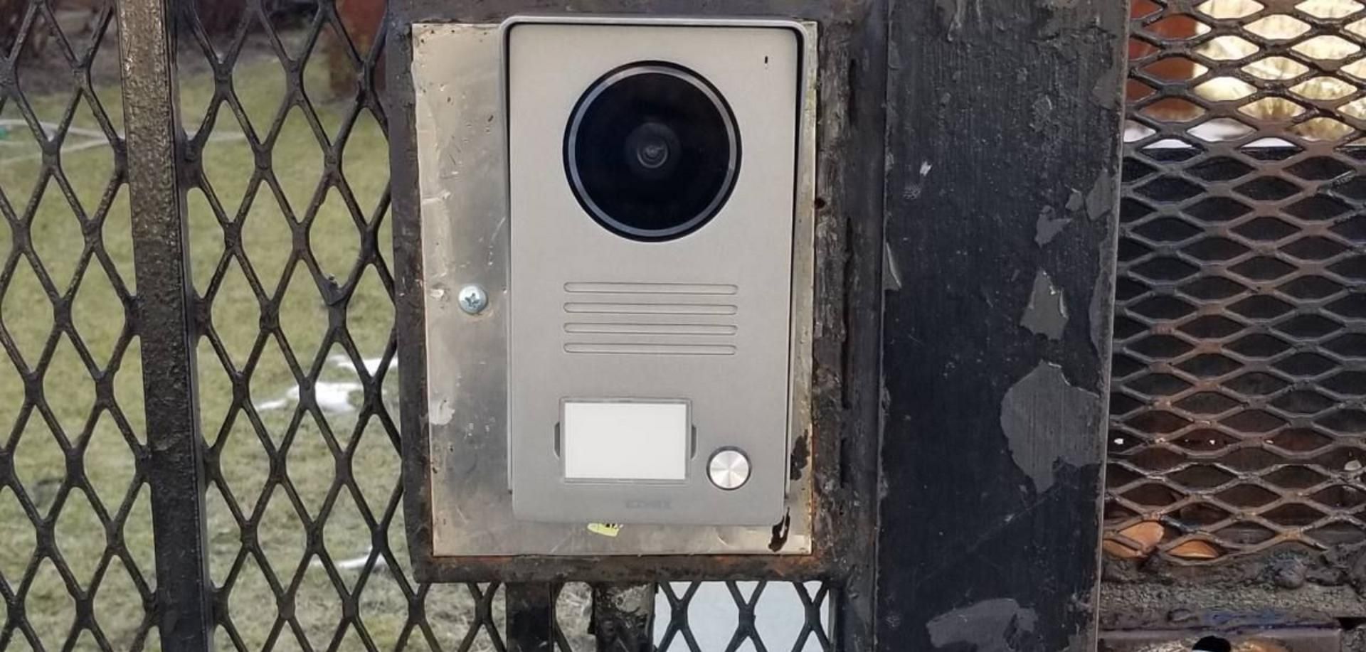 Elvox video intercom door station mounted on a steel mesh entry gate at 218 Gates Avenue, Bed-Stuy, Brooklyn