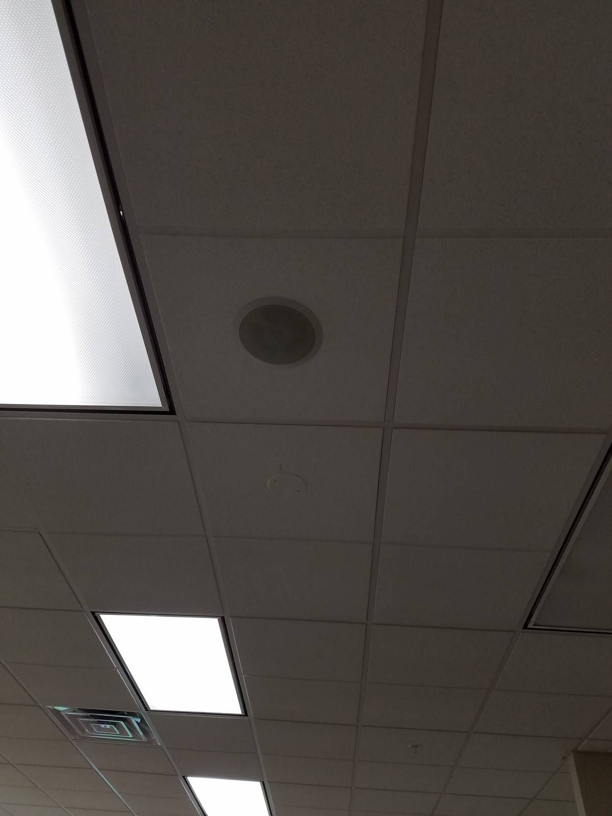 Ceiling-mounted PA speakers spaced across an office floor at a church in West Orange, New Jersey