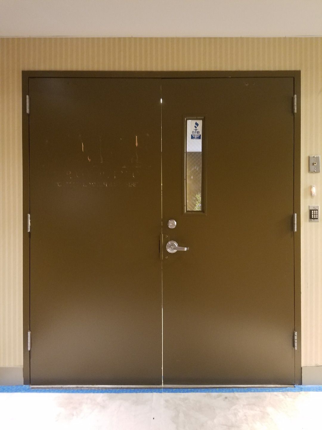 Existing office entrance doors at CM&F Group before replacement — exterior view