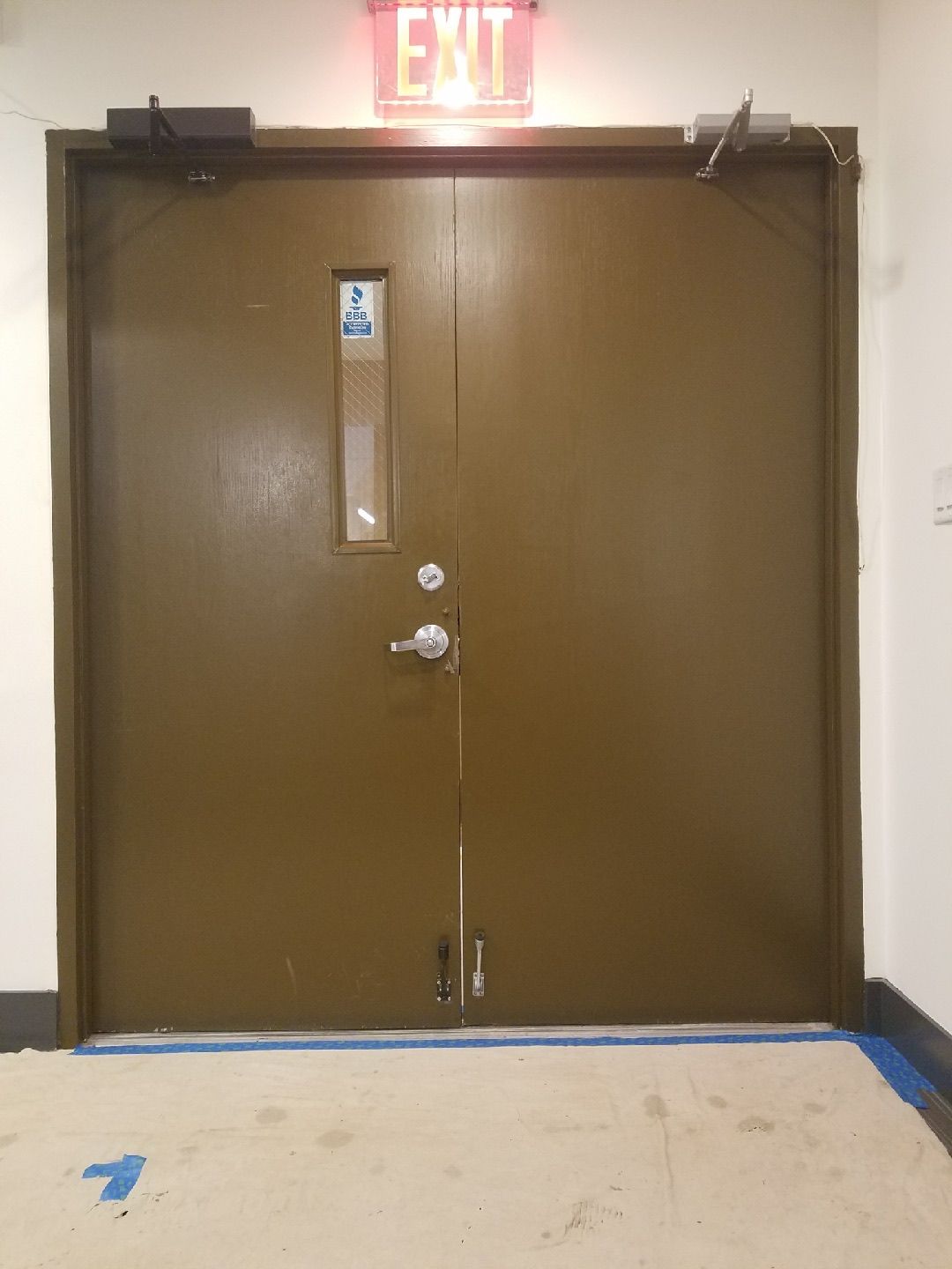 Existing interior office doors at CM&F Group before the Herculite door installation