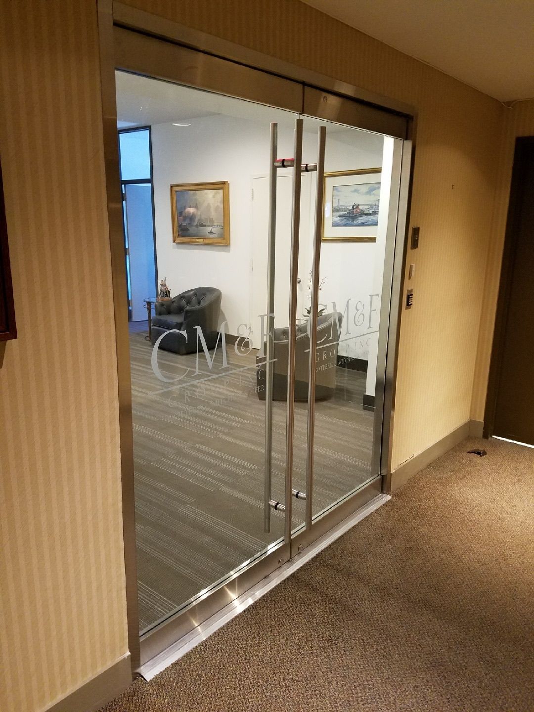 Completed Herculite glass door installation at CM&F Group Manhattan office — side elevation