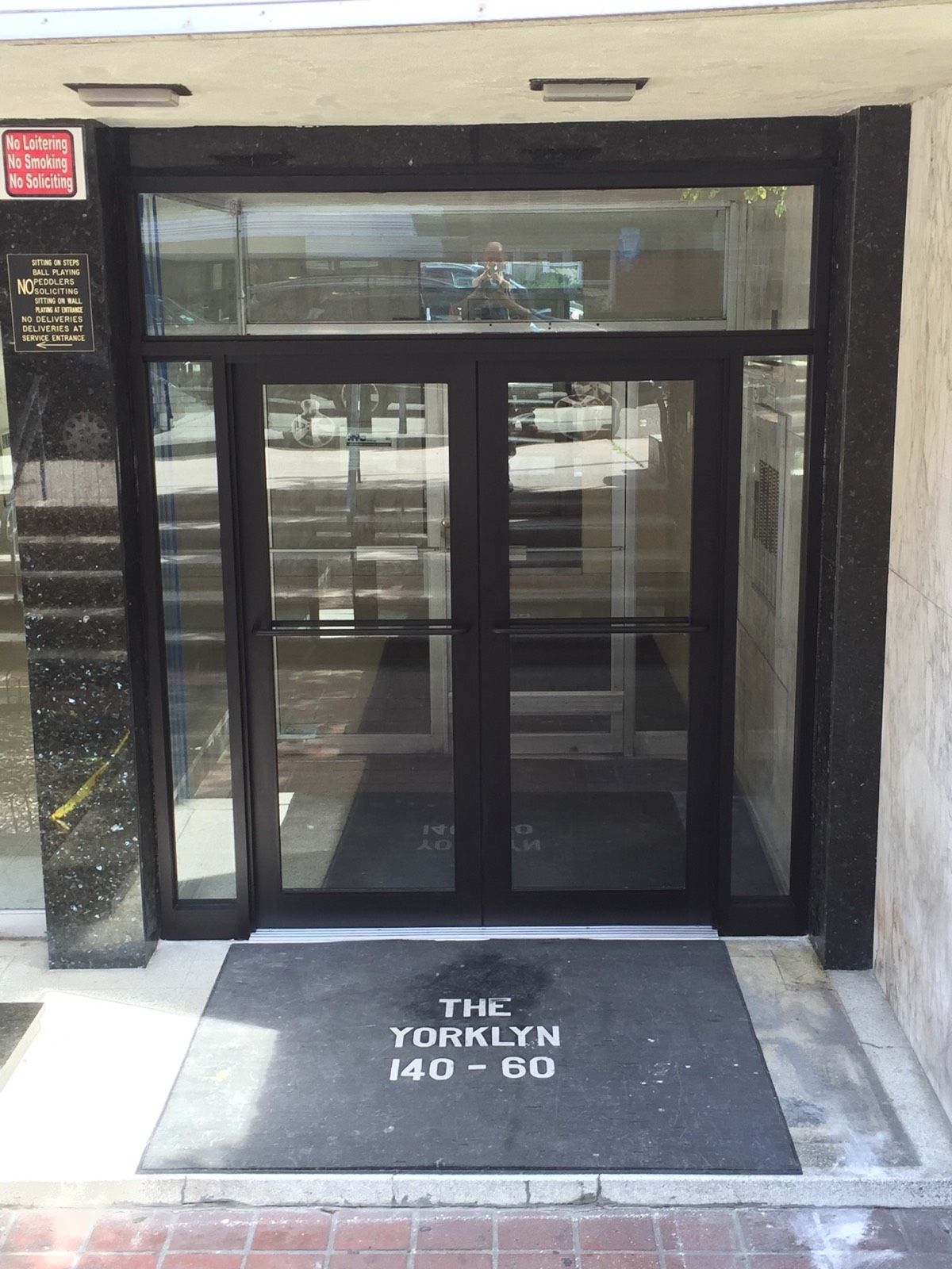 New commercial front entrance door with black aluminum framing in Flushing, Queens