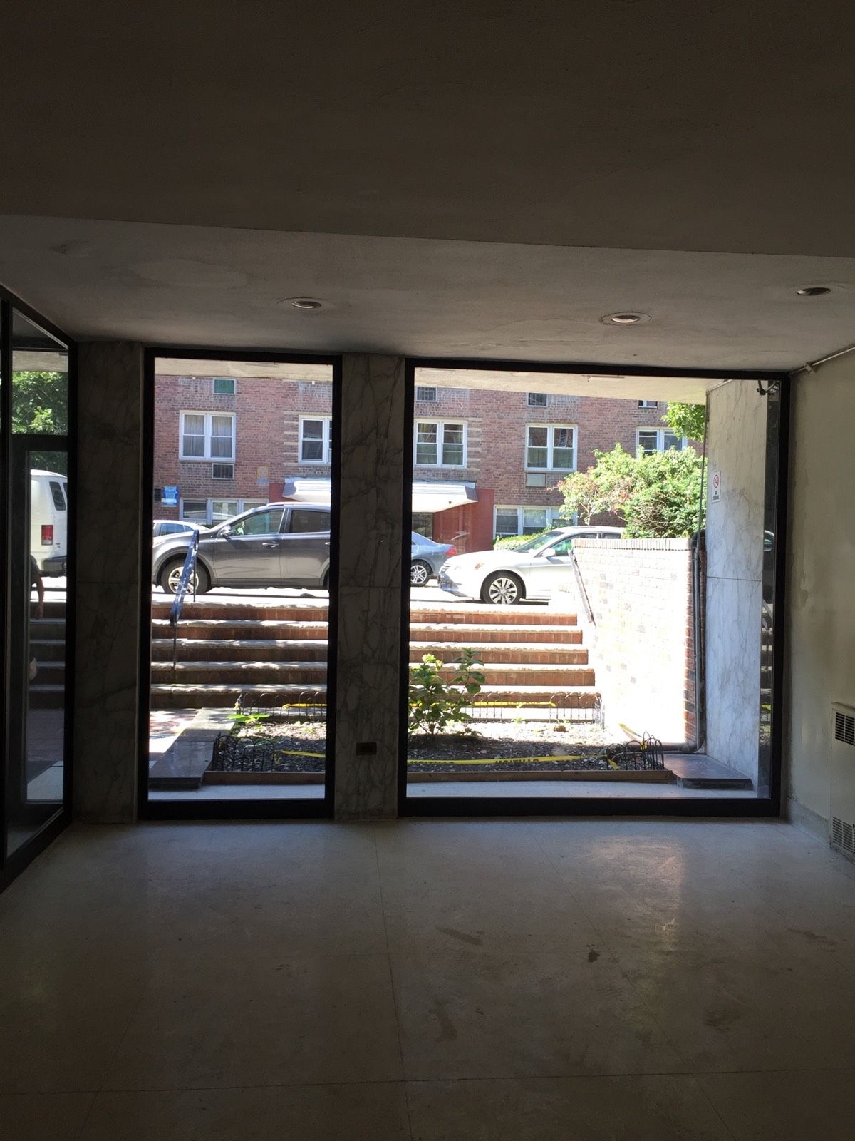 Interior view of new side-lite glass panels and framing at a Flushing, Queens vestibule