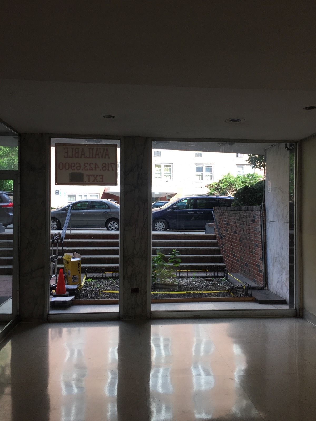 Original side-lite glass panels before entrance renovation at a Flushing, Queens apartment building