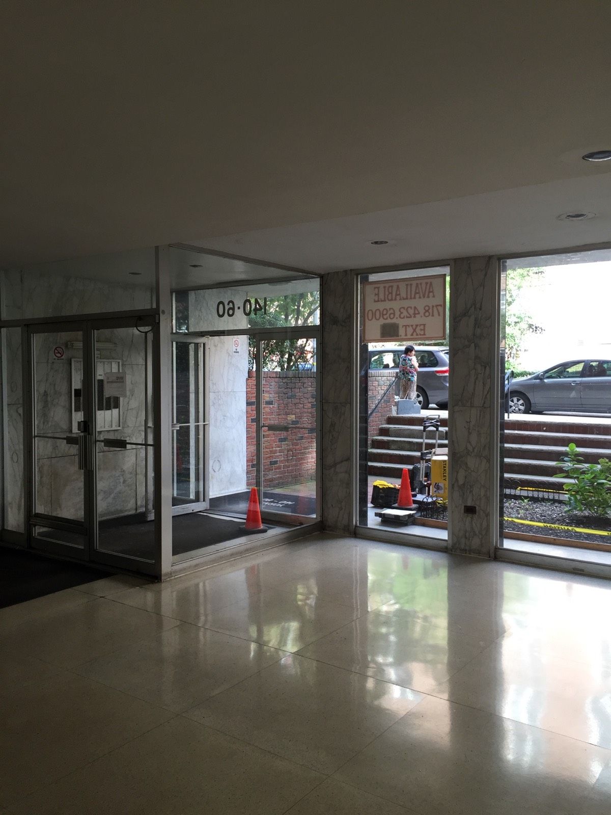 Original aging aluminum vestibule at a Flushing, Queens multi-tenant building before replacement