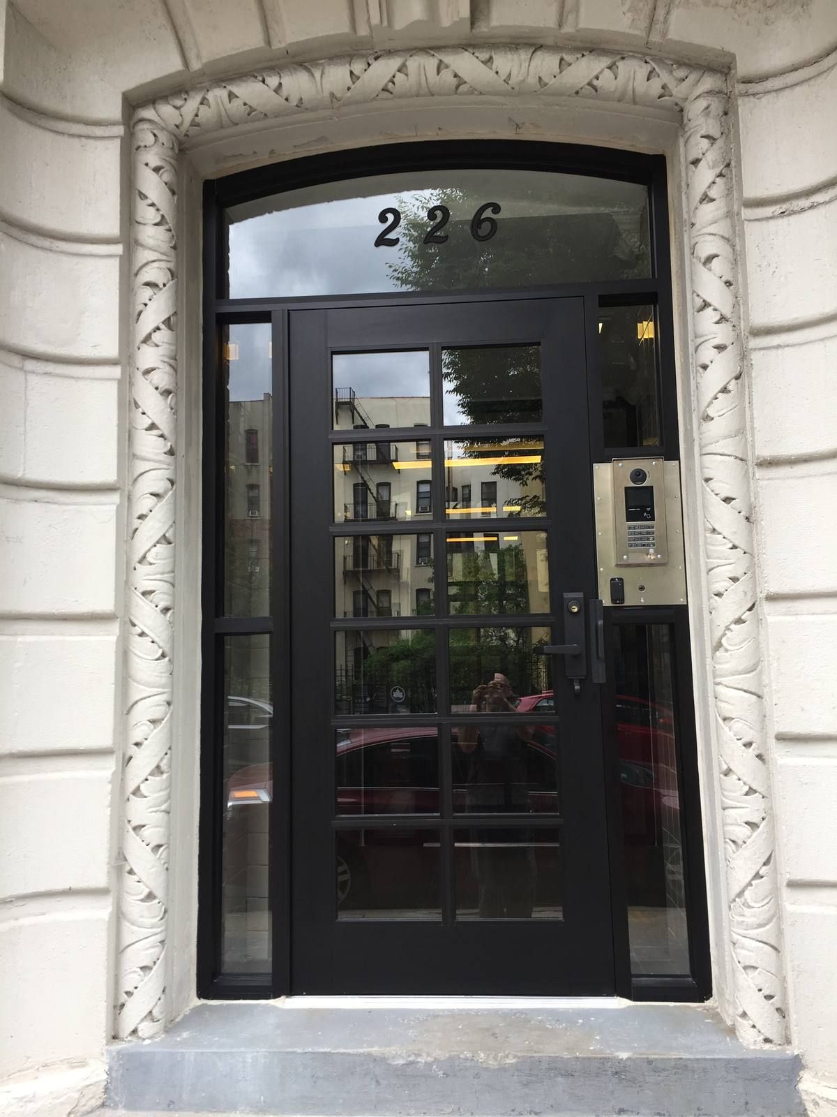 Harlem co-op entrance door with a video intercom and keypad/card access-control panel