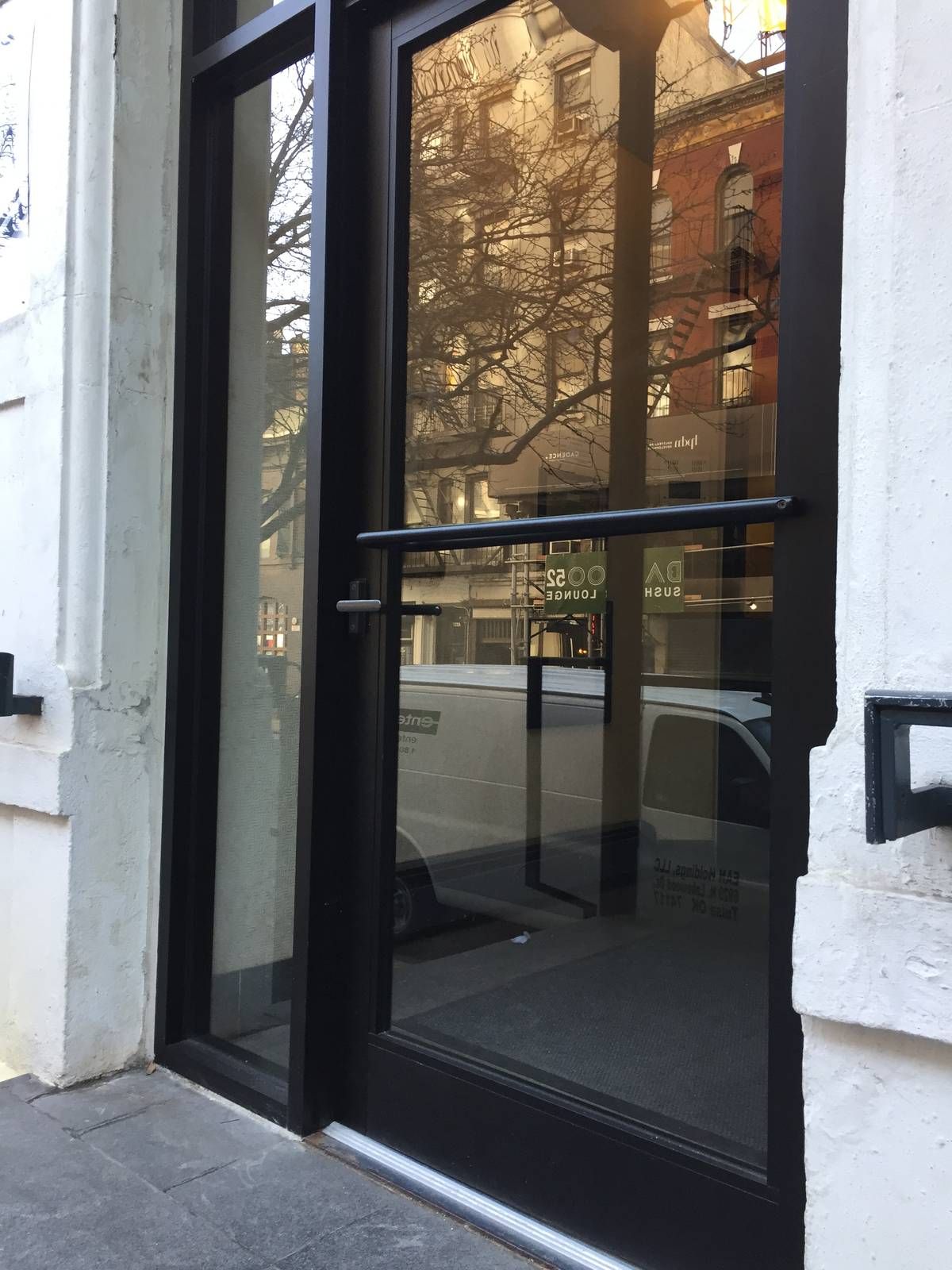 New black narrow-stile aluminum entrance door at 325 West 52nd Street in Hell's Kitchen, Manhattan