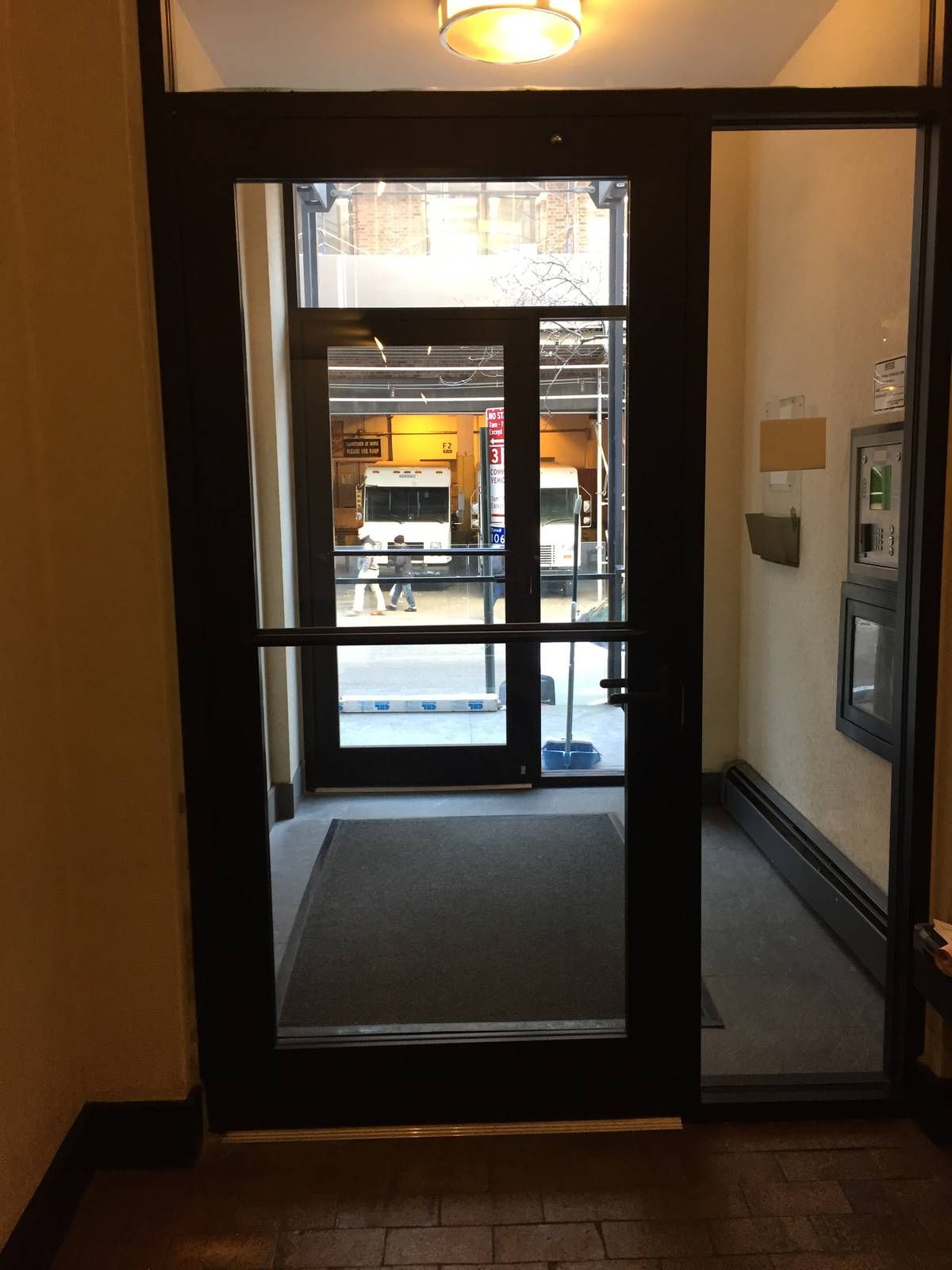 View through both new aluminum vestibule doors to West 52nd Street in Hell's Kitchen, Manhattan