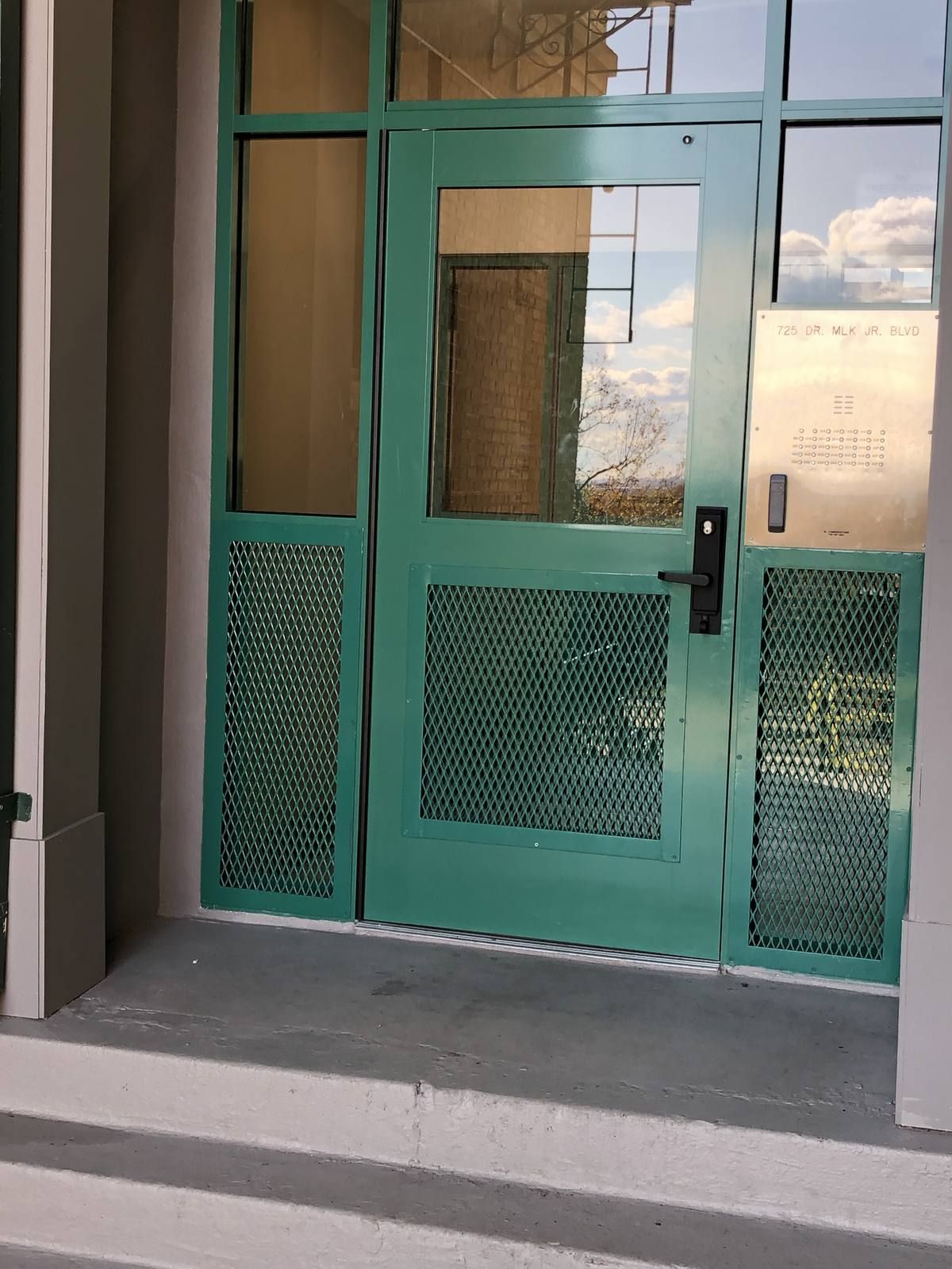 New aluminum storefront entrance door with intercom and access control panel at a Newark NJ apartment building