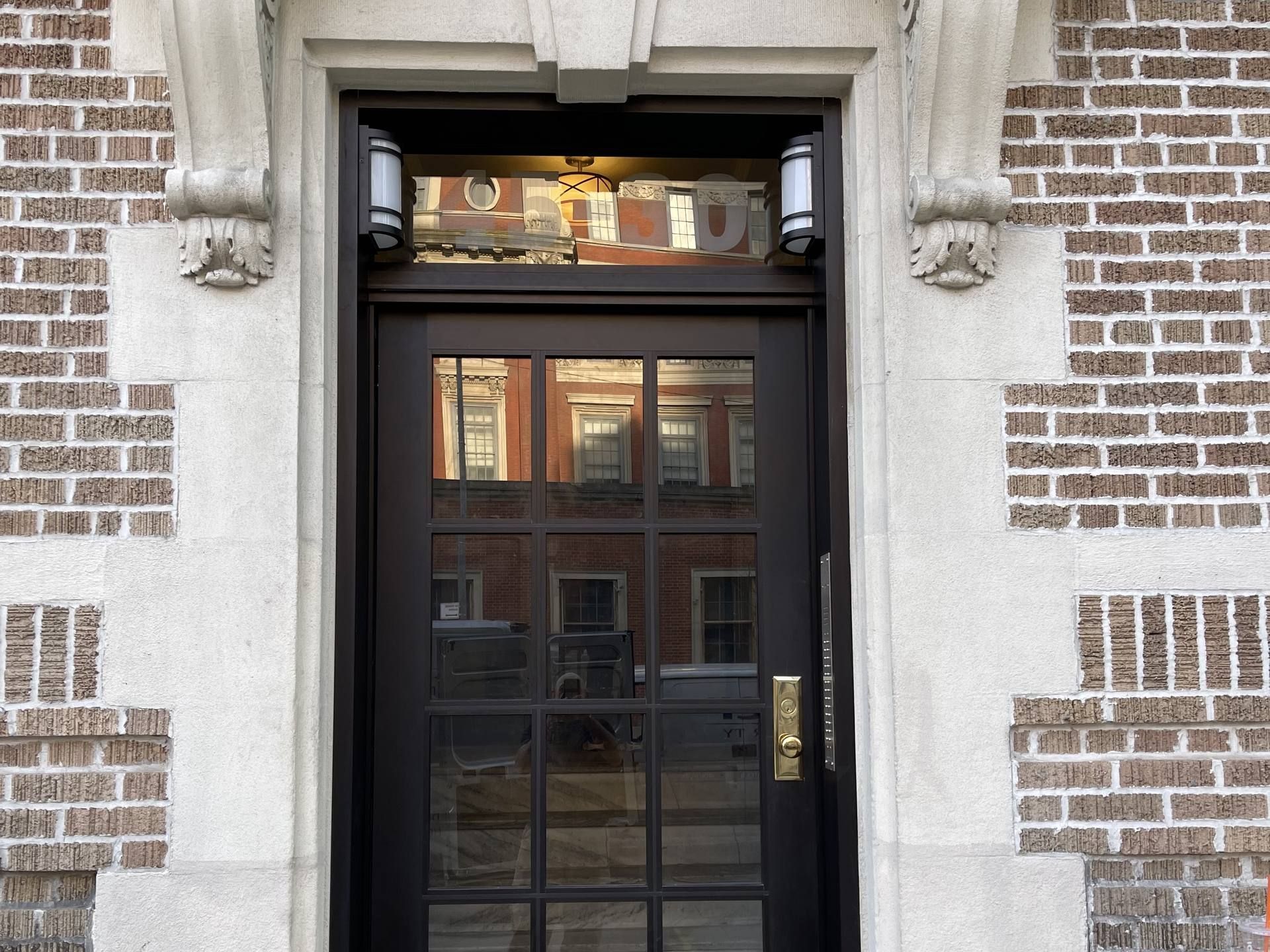 Self-locking glazed entrance door at a New York City apartment building, the entry governed by MDL 50-a