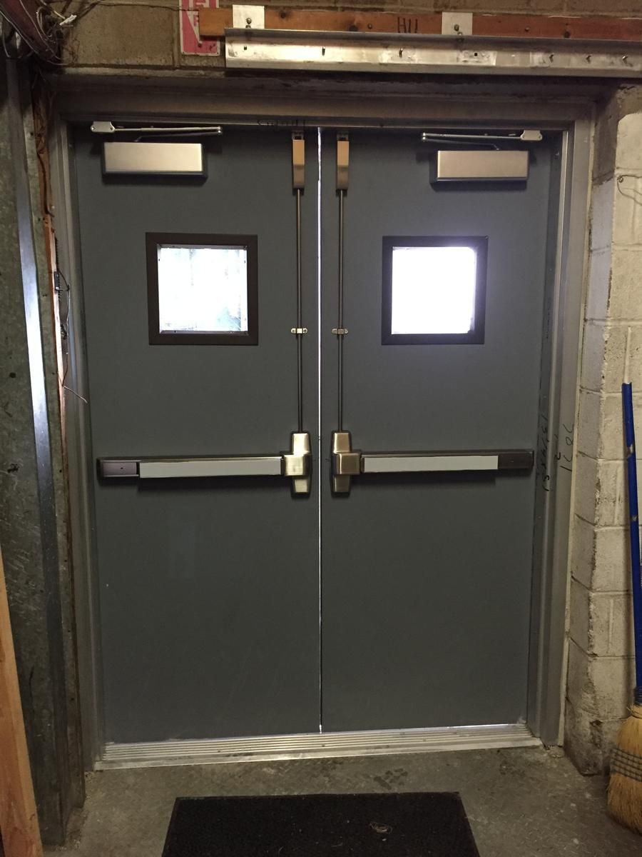 New hollow metal double doors with vertical rod panic exit devices, closers, and vision lites in Glen Rock, NJ