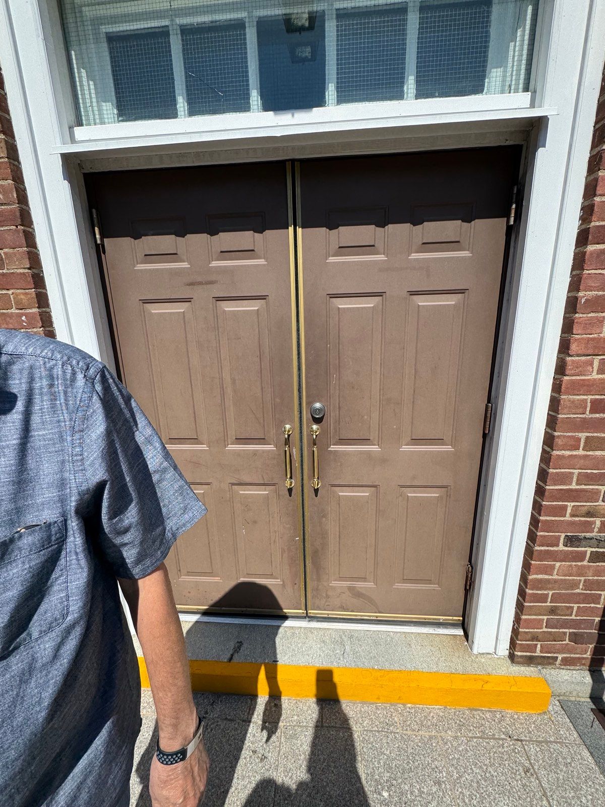 Exterior entrance door with keyed deadbolt cylinder at St. Clare's Church, Staten Island, NY