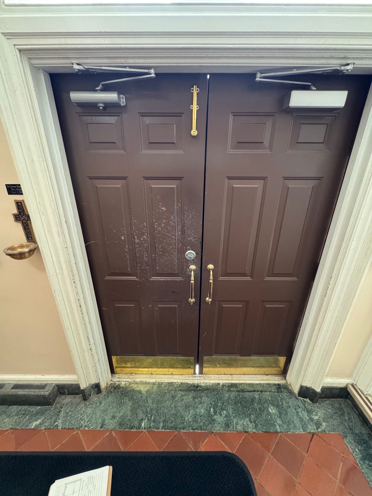 Interior view of a finished entrance door with panic hardware at St. Clare's Church, Staten Island