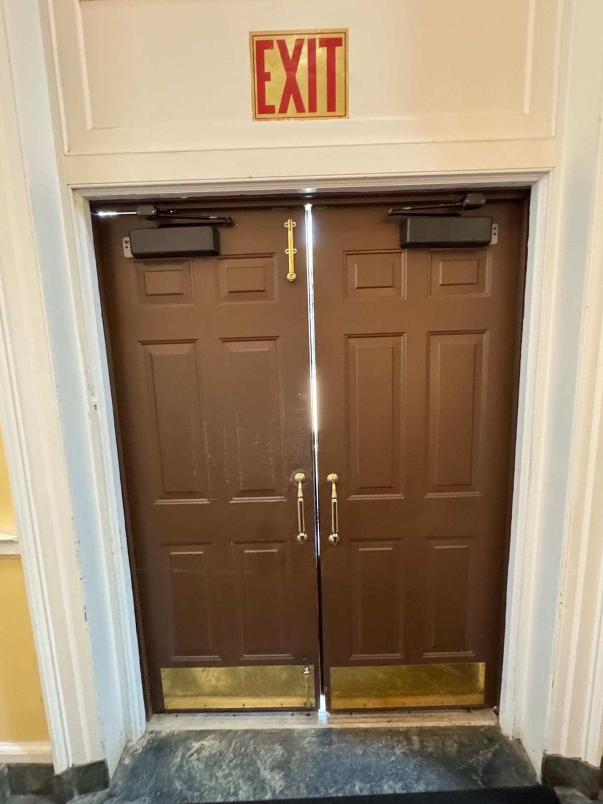 Interior view of a door with panic exit hardware and EXIT signage at St. Clare's Church, Staten Island, NY