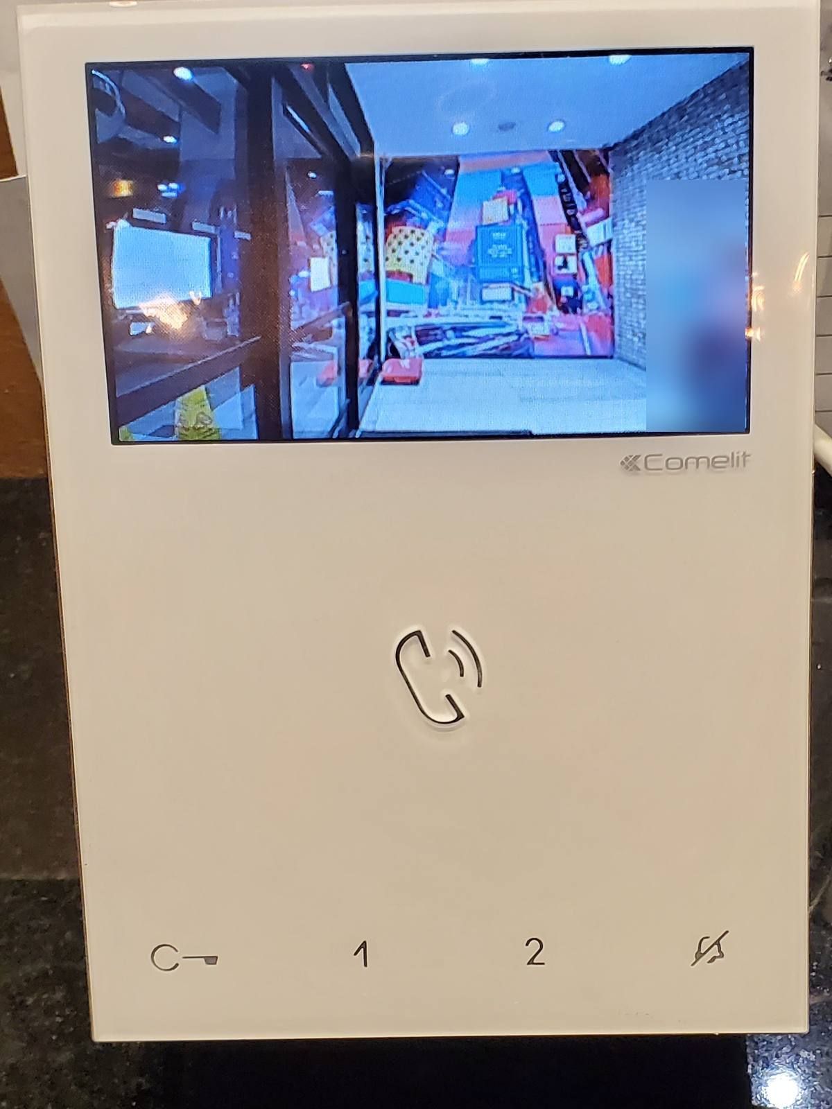 Comelit hands-free color video intercom monitor on a hotel front desk in Midtown Manhattan