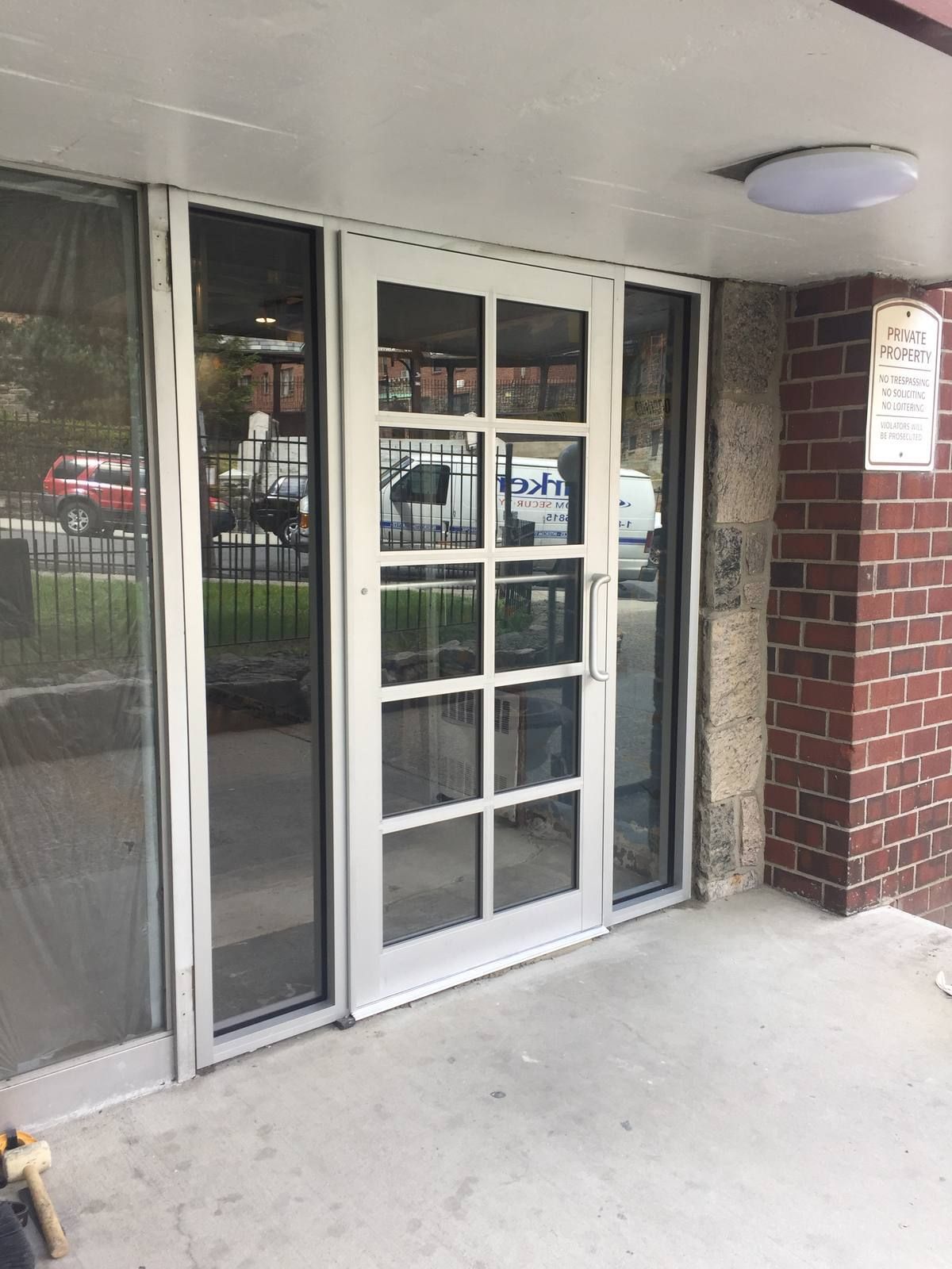 Side view of a new aluminum entrance with glass sidelites at a Westchester apartment building