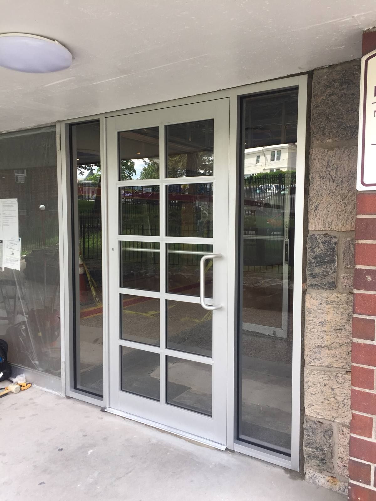 Close-up of a new aluminum colonial grid entrance door with D-pull handle and sidelites in Yonkers, NY