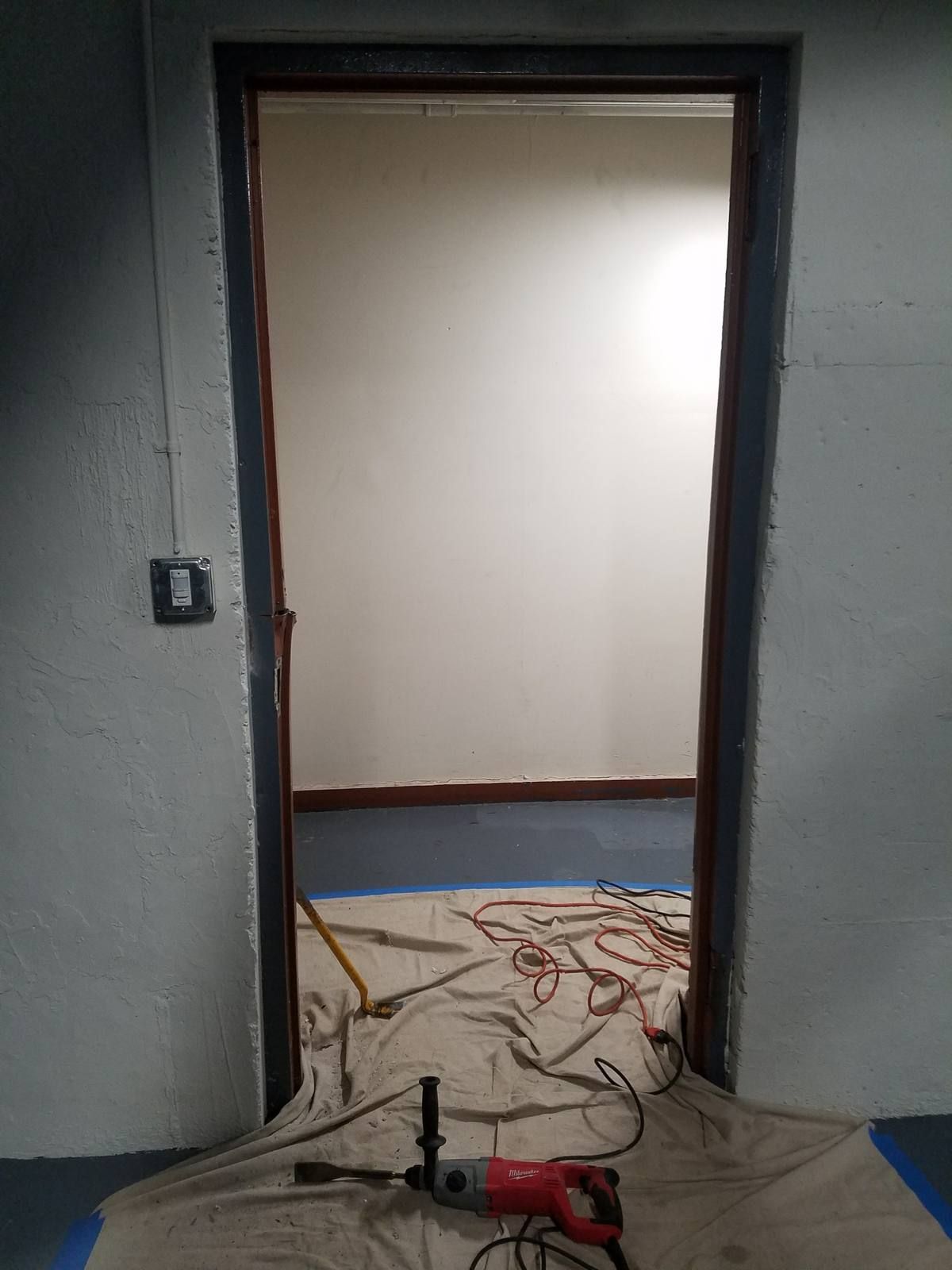 Masonry door opening prepared for a new steel frame inside a Yonkers apartment building