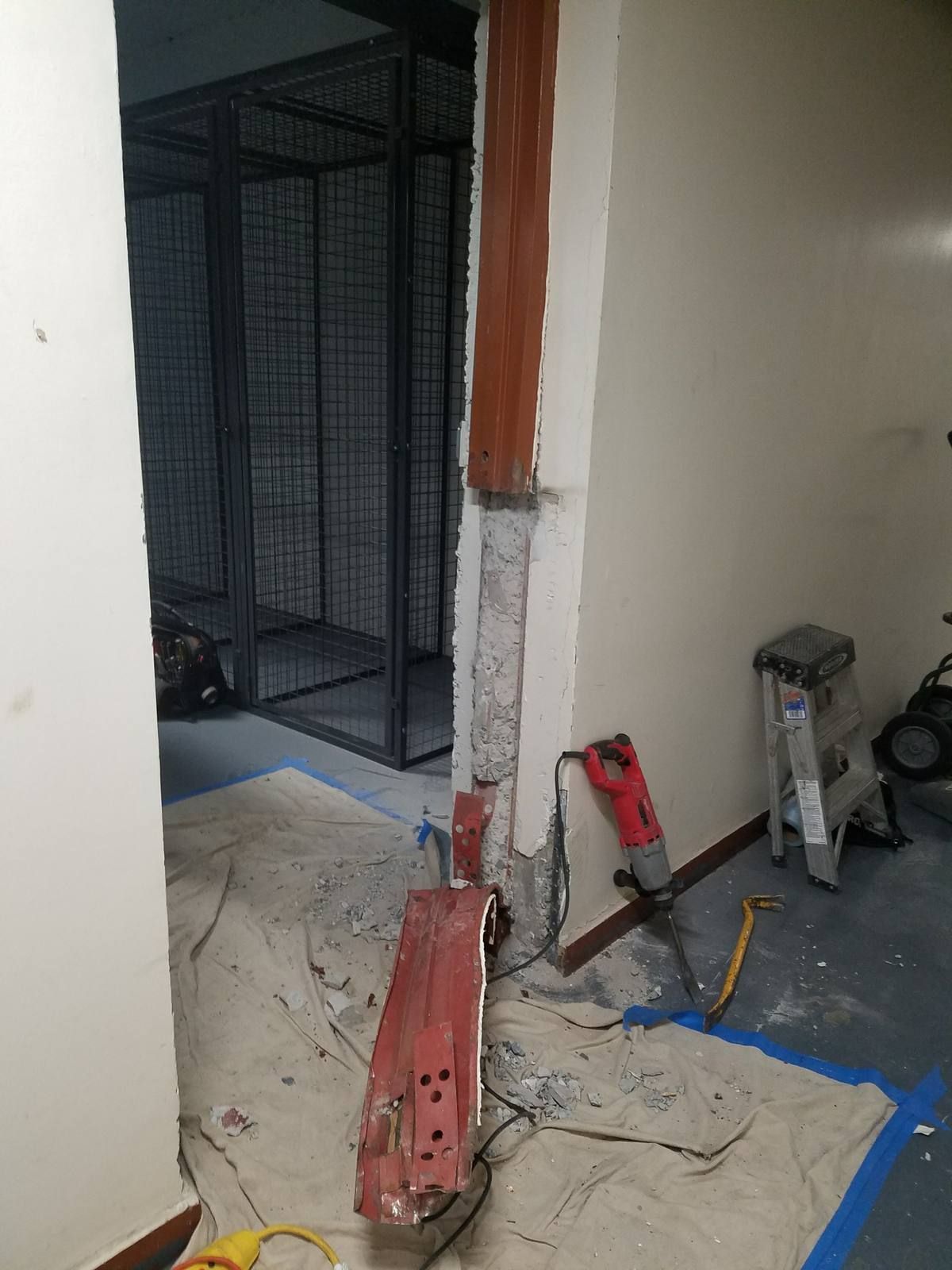 Old steel door frame cut out of a masonry opening before a new hollow metal door installation in Yonkers