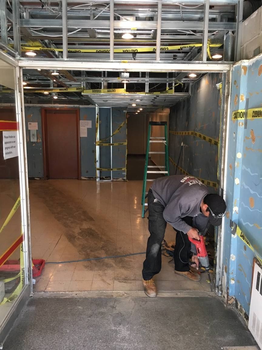 Parker technician removing the old vestibule framing during a lobby renovation in Yonkers, NY