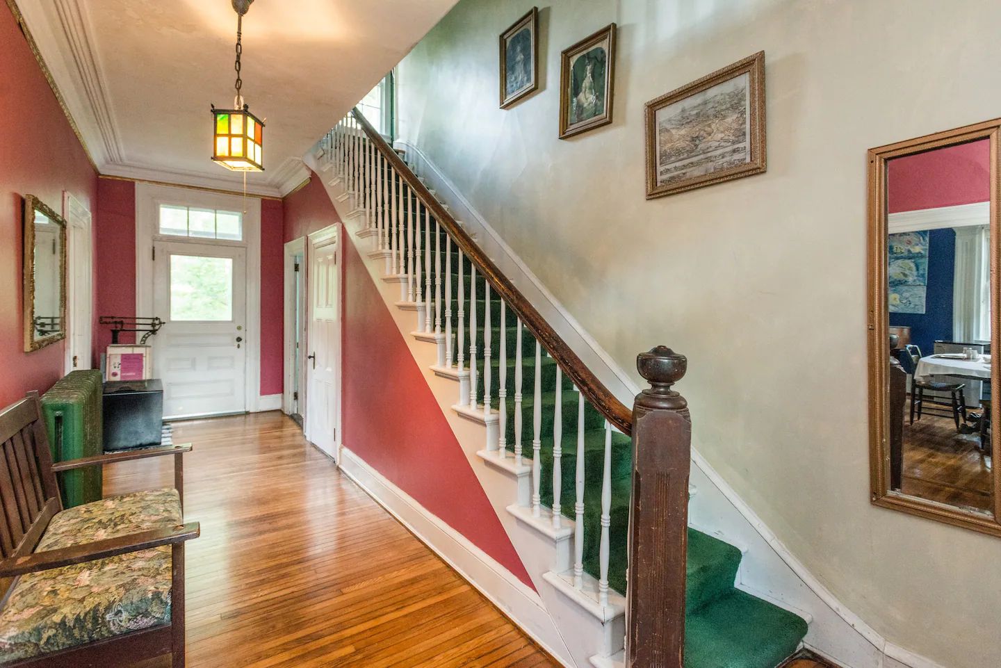 A hallway with stairs leading up to the second floor of a house.
