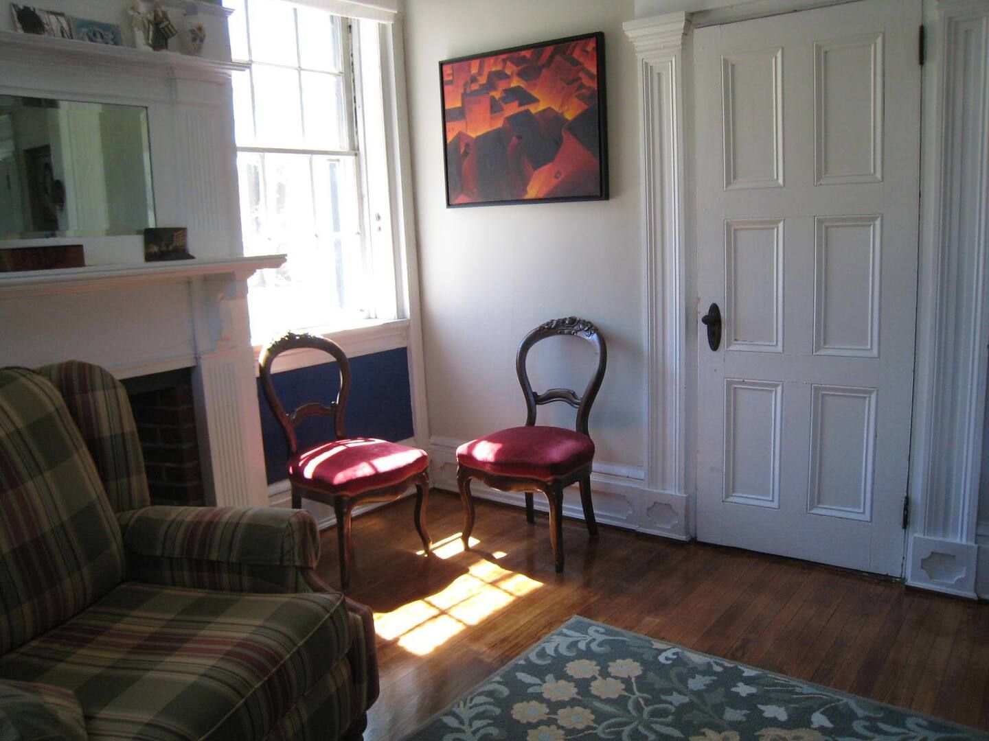 A living room with two chairs and a fireplace
