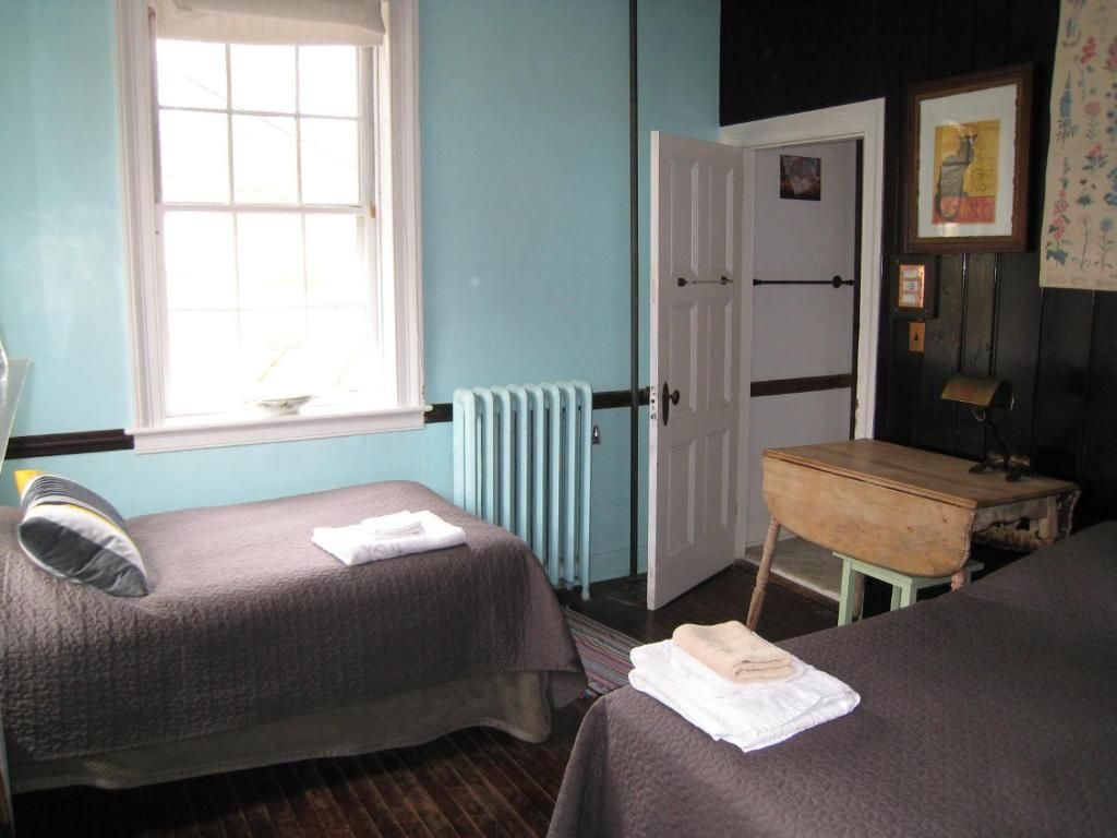A bedroom with two beds and a radiator
