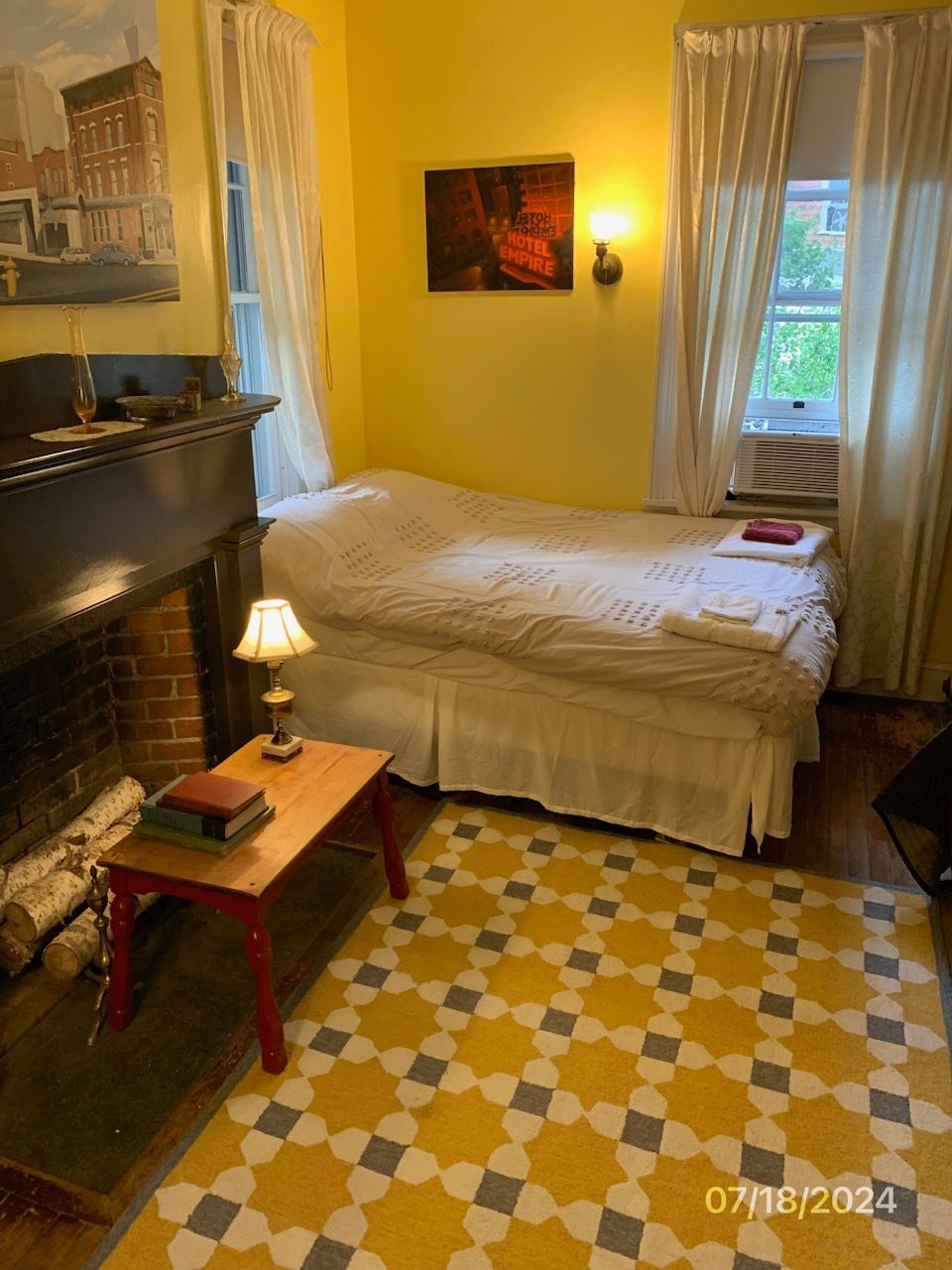 A bedroom with a fireplace and a bed