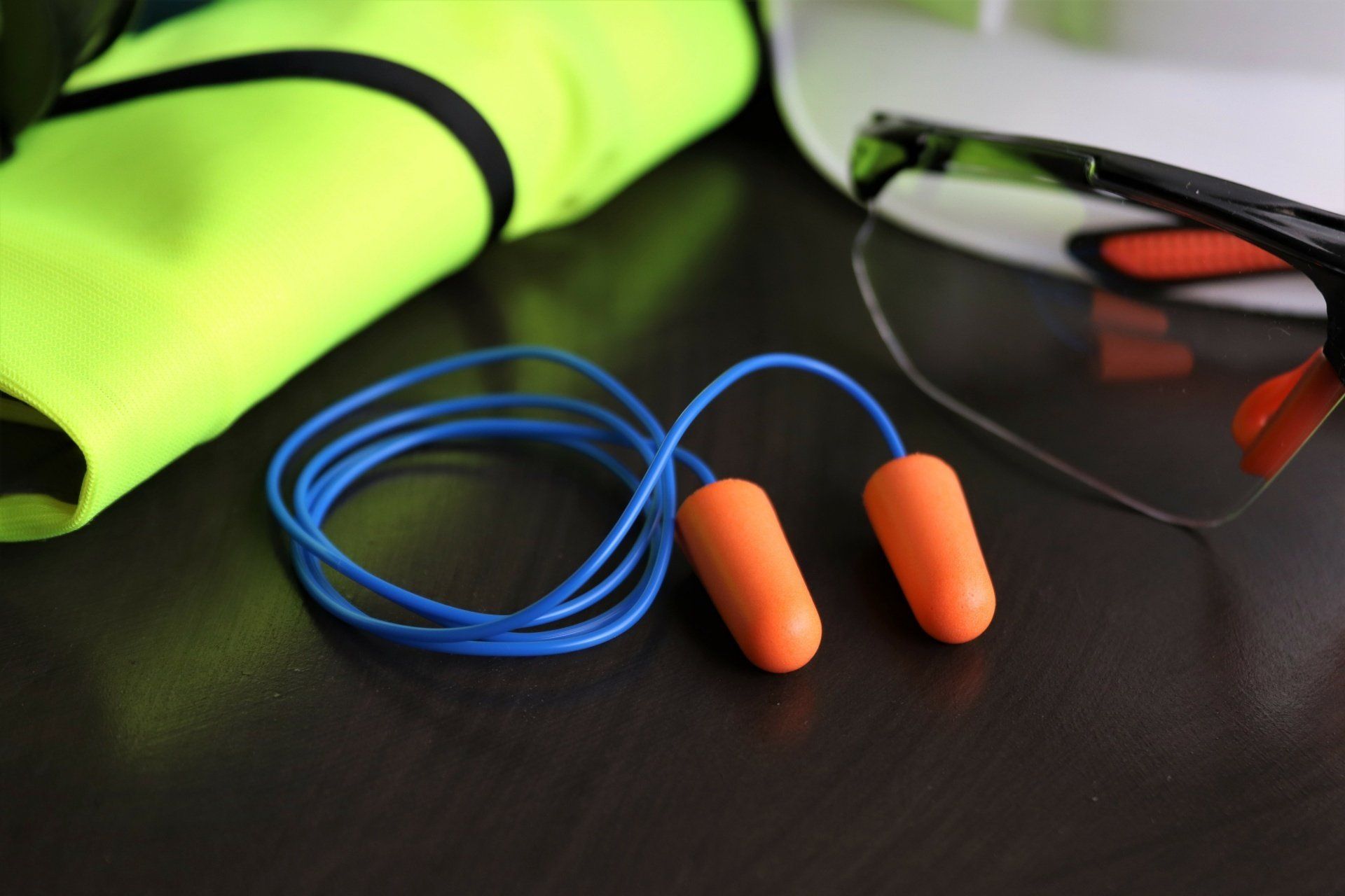 Disposable earplugs on table with other PPE